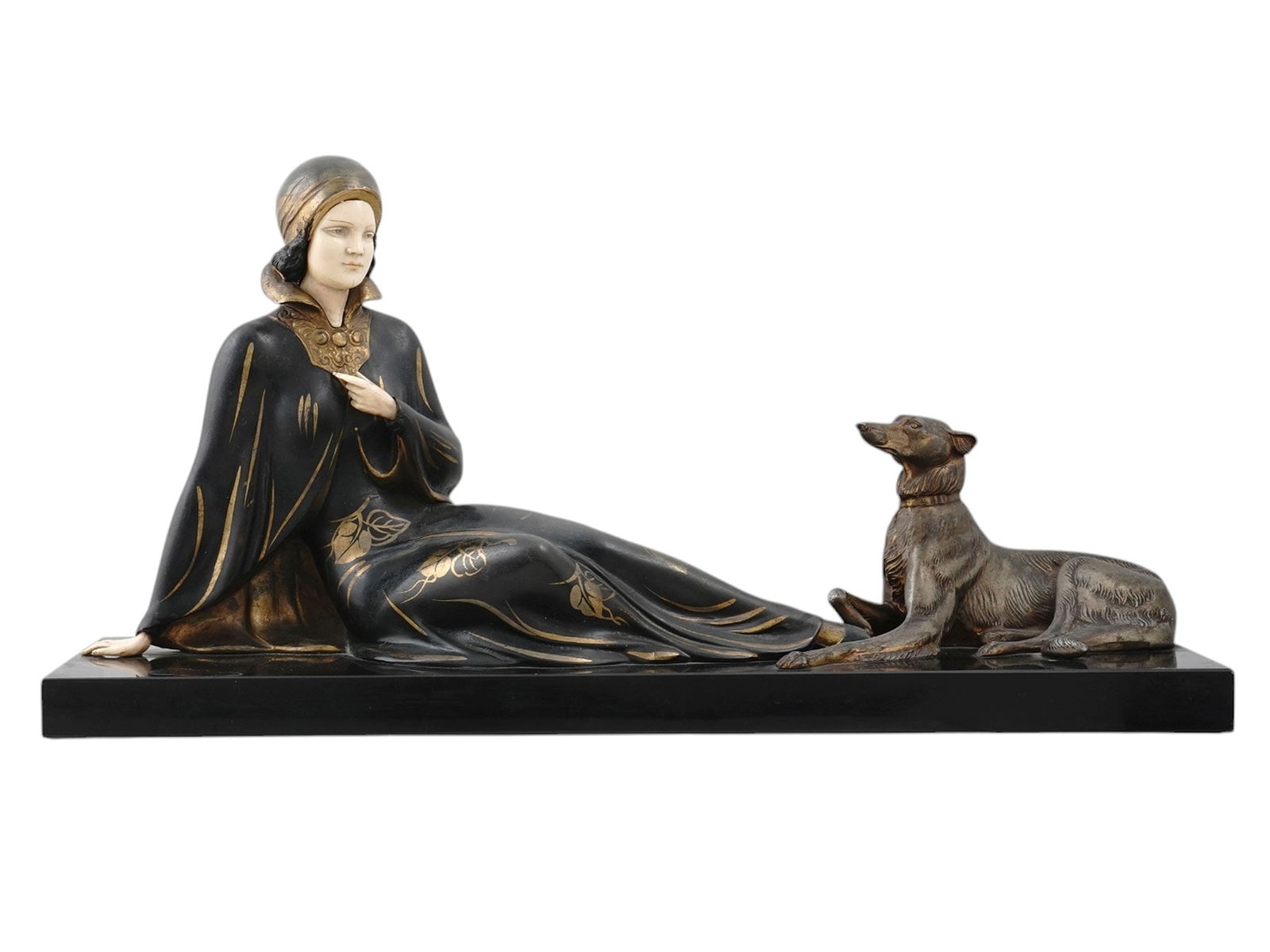 AN ART DECO SCULPTURE OF A YOUNG WOMAN WITH A GREYHOUND, CA. 1930: Painted metal sculpture of a young woman with a greyhound on a black marble base. Early 20th century. Dimensions: 22 1/4 x 11 5/8 x 6 1/2 in., (56.5 x 29.5 x 16.5 cm.) Please make all inquiries before