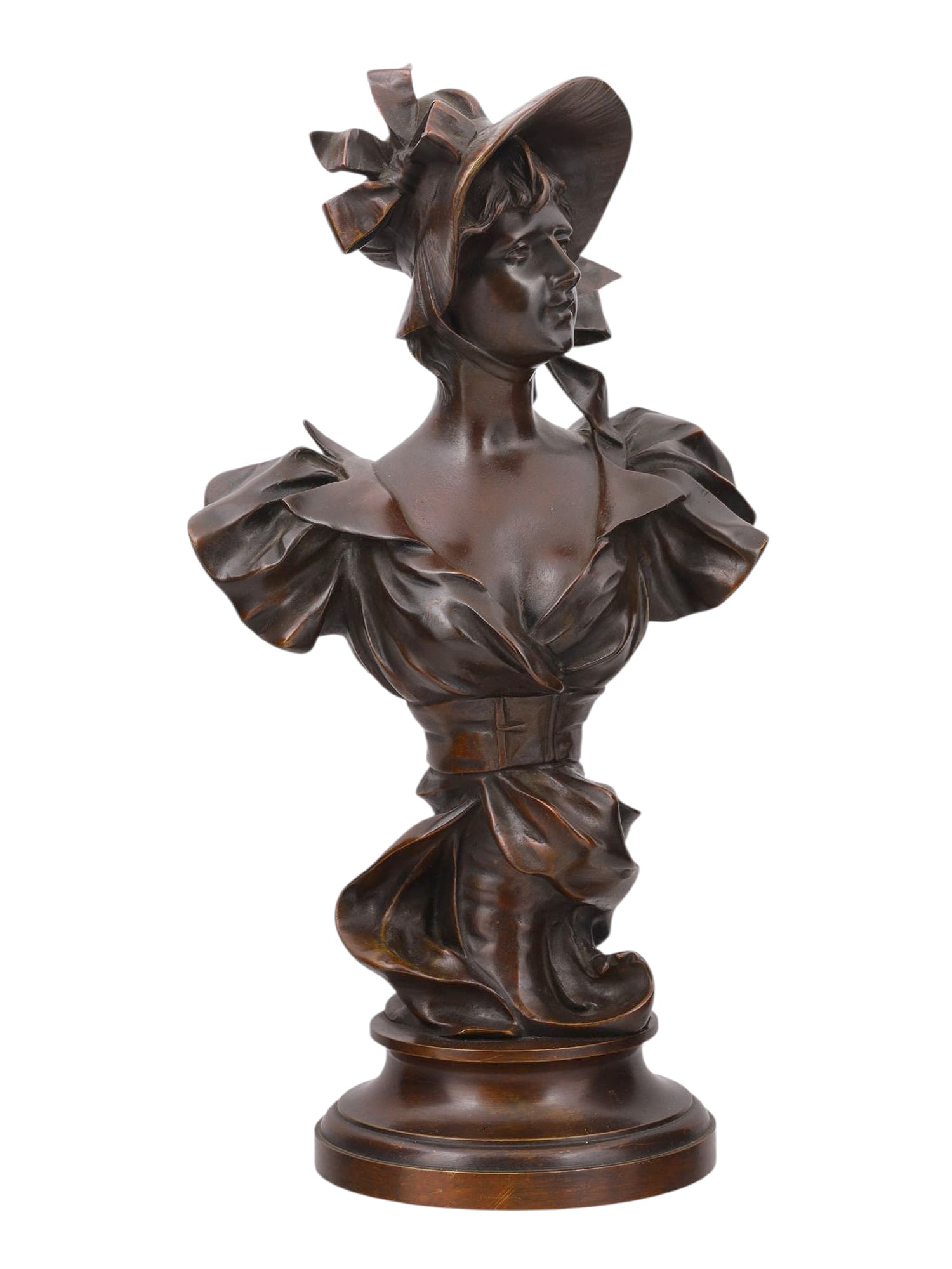 A SIGNED GEORGES COUDRAY (1862-1944) BRONZE OF A LADY IN A BONNET, 19TH CENTURY: A bronze bust by French sculptor Georges Charles Coudray (1862-1944) depicting a young woman in a dress and bonnet, composed in the art nouveau style. The piece is signed near the bottom by the artist