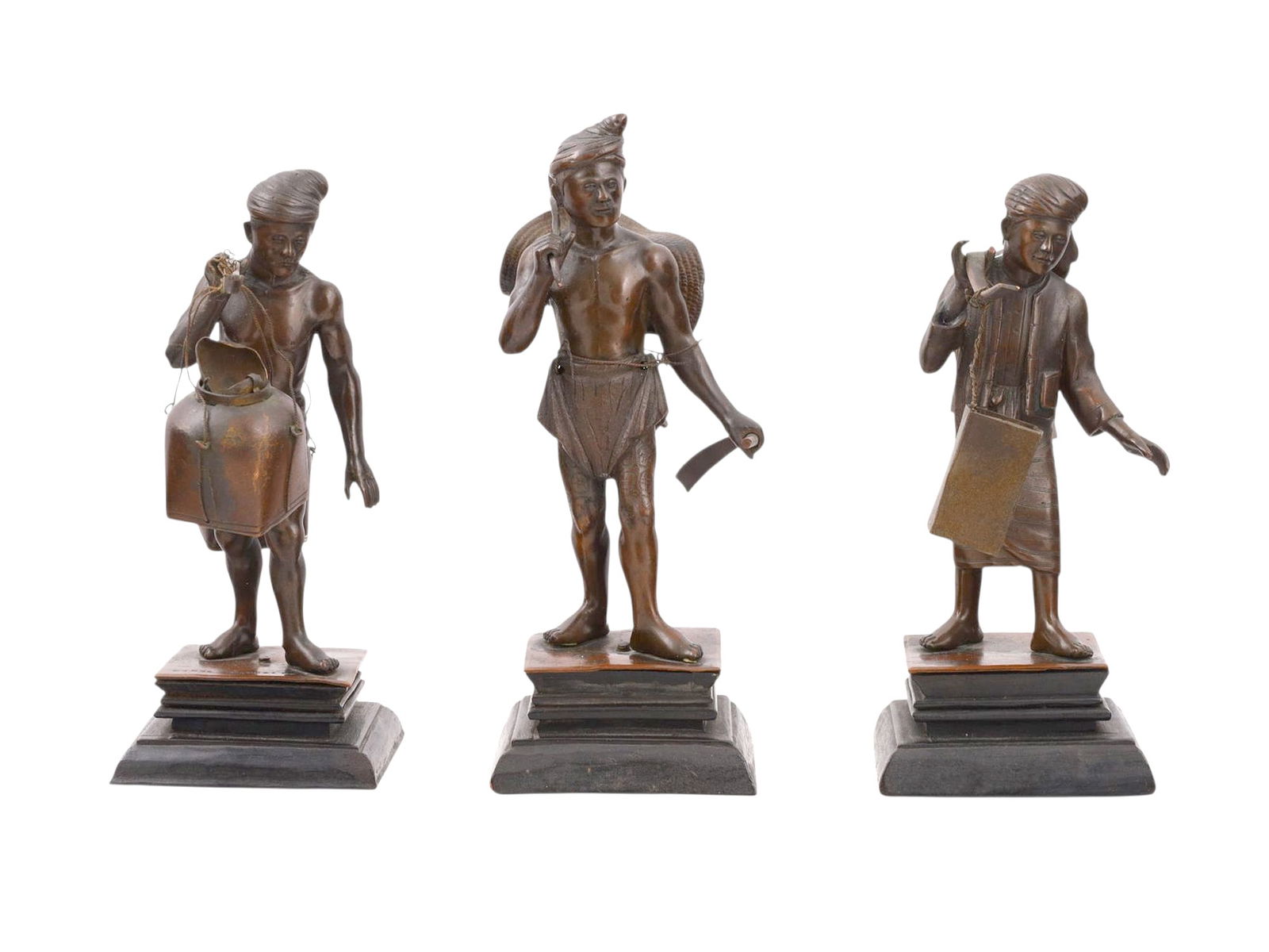 A SET OF THREE BURMESE BRONZE FIGURES, MANDALAY, EARLY 20TH CENTURY: ach finely cast and detailed, depicting Burmese peasants engaged in daily tasks: one carrying a large vessel suspended from a yoke, another with a basket and tool, and the third with a large cleaver a