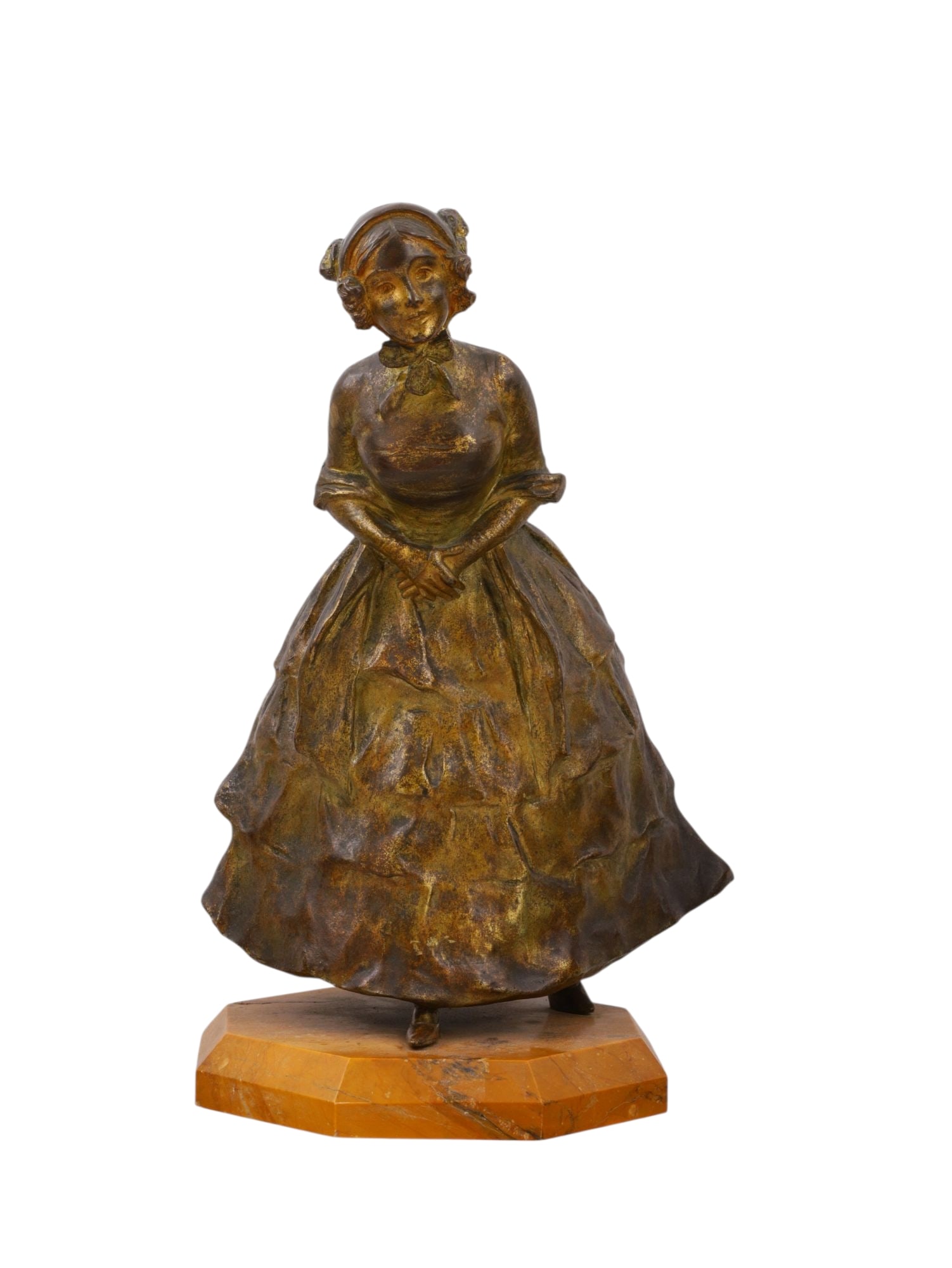 A GOLDSCHEIDER BRONZE GIRL ON MARBLE BASE, CIRCA 1900: A finely cast and patinated bronze figure of a young girl in a bonnet and layered dress, leaning forward with hands clasped demurely before her, mounted on an octagonal sienna marble base. The natural