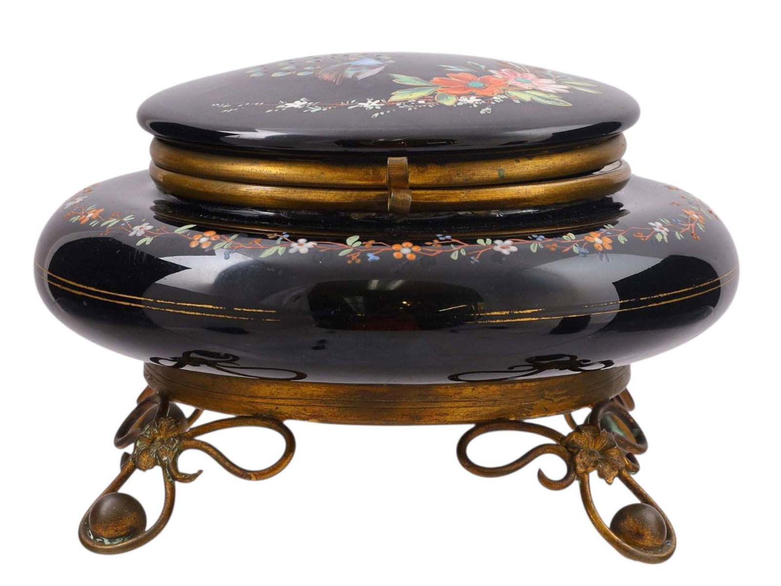 A BOHEMIAN MOSER GLASS BOX WITH ENAMEL DECORATION, LATE 19TH CENTURY: Of circular cushion form with hinged lid, the deep amethyst glass body finely hand-enameled with a continuous floral garland of orange, white, and blue blossoms with trailing vines, further enriched w