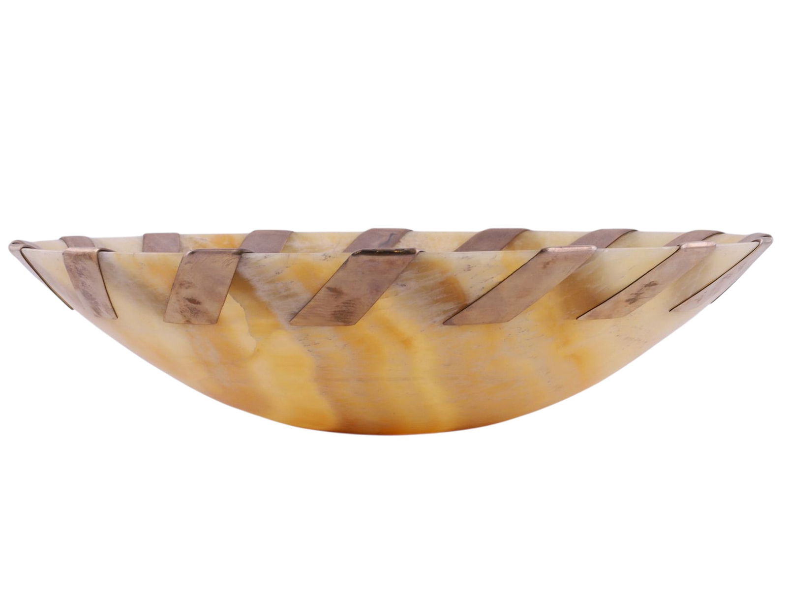 A JOHN HARDY LARGE SILVER-MOUNTED CARVED-ONYX CHARGER: A substantial decorative charger by John Hardy, finely carved from banded honey-toned onyx and mounted at the rim with alternating geometric silver segments. The shallow circular form is carved from a