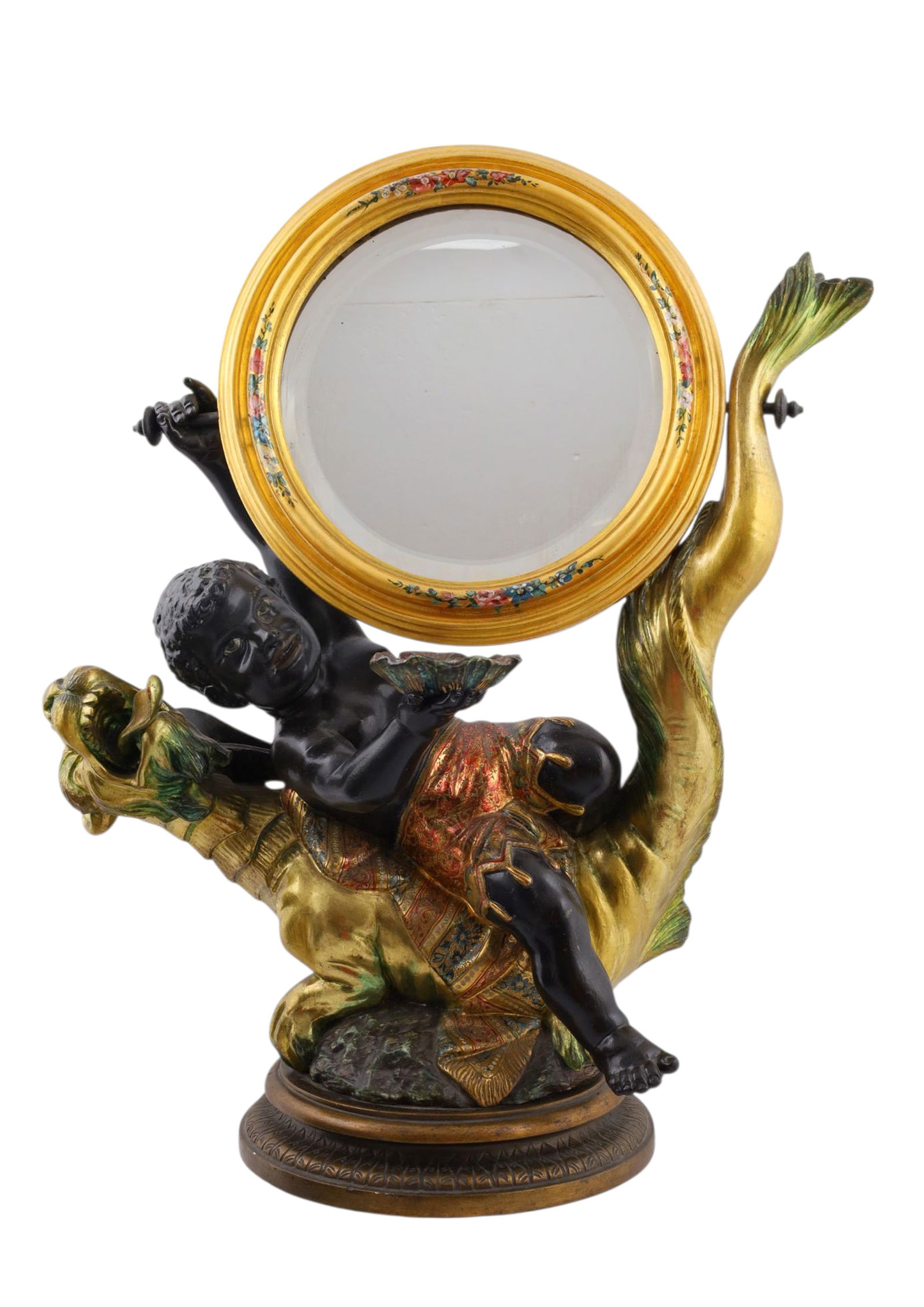 A VENETIAN OR FLORENTINE PAINTED AND GILT HAND-CARVED WOOD MIRROR, 19 C.: The figural mirror, finely carved and polychrome-painted, modeled as a putto with blackamoor features astride a gilt dolphin, the circular mirror framed in a giltwood surround with floral-painted deco