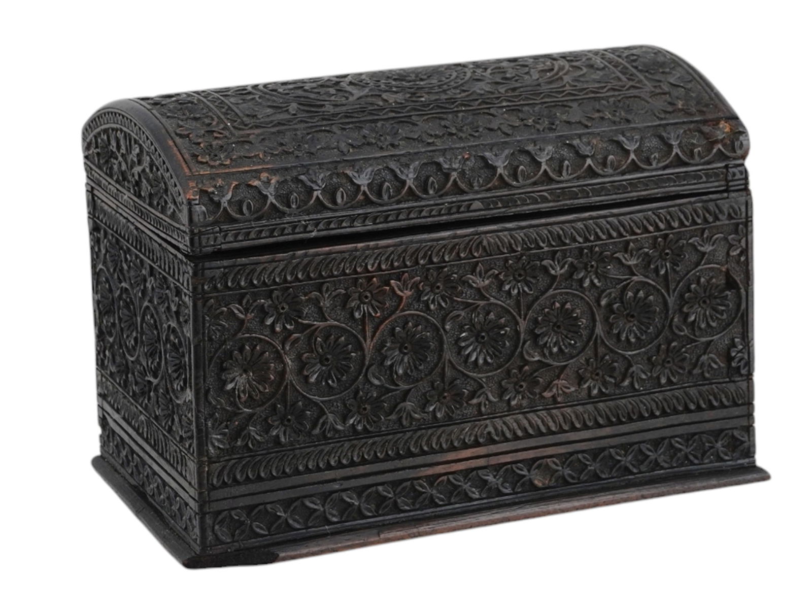 AN INDIAN CARVED WOODEN LIDDED BOX, 19TH CEN.: An Indian lidded box nicely carved from dark stained wood with intricate floral motifs in low relief across its entire surface. The domed lid attached to the rectangular box via two brass hinges. Indi