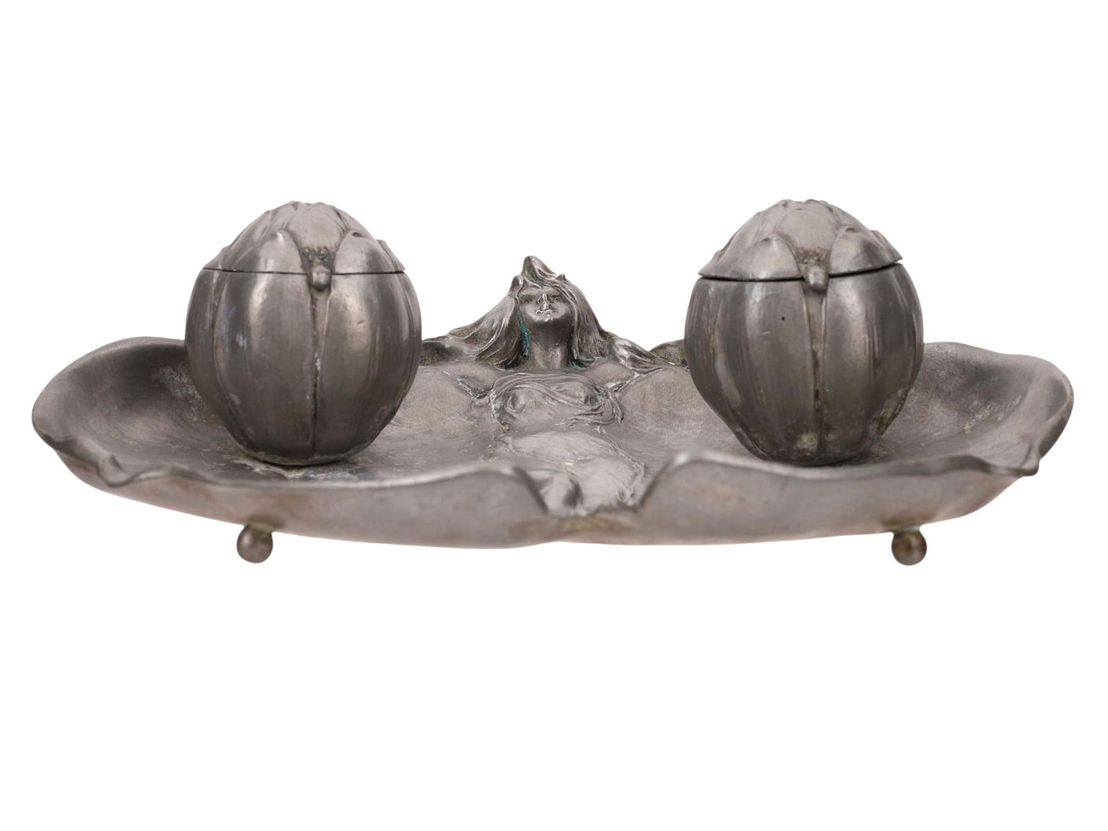 A GERMAN JUGENDSTIL ART NOUVEAU PEWTER DUAL INKWELL SET SIGNED "H.M", 19TH/20TH CEN.: An attractive jugendstil or art nouveau style dual inkwell set shown as a woman with her arms outstretched from which two large lilypad like leaves hang down, the inkwells appearing as the unbloomed f