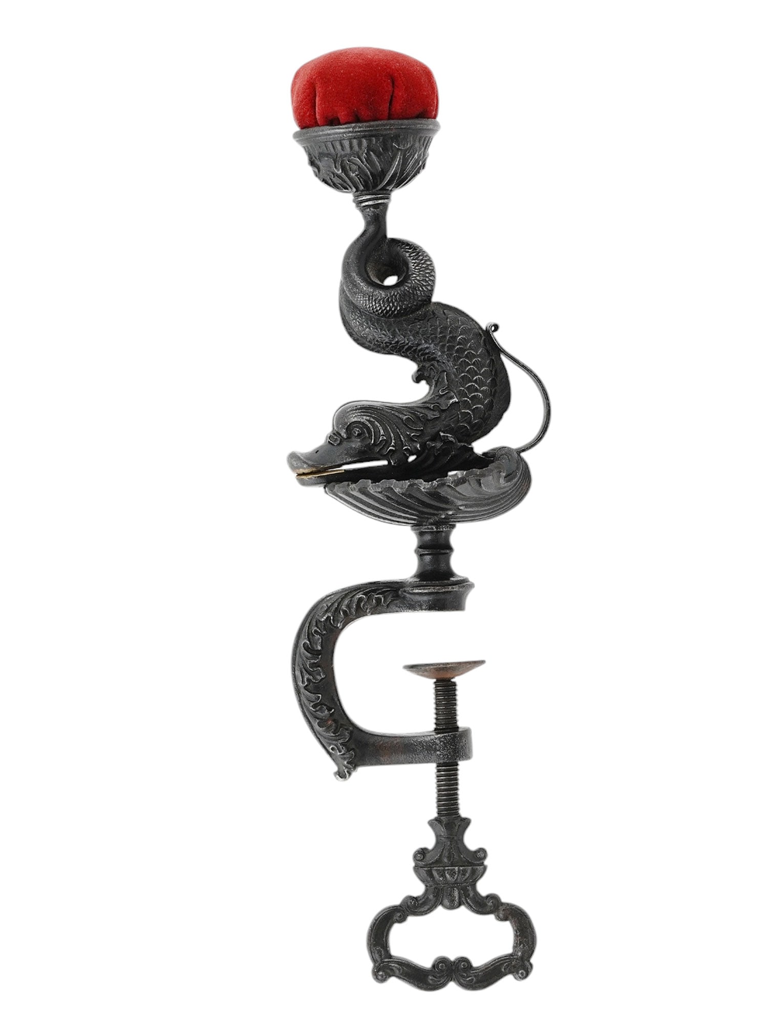 A EUROPEAN CHASED IRON SEA SERPENT PINCUSHION WITH TABLE MOUNT, 19 C.: An ornate, chased iron, table-mounted pincushion in the shape of a sea serpent sat atop an open clamshell, its tail spiraling up and finishing in the red pincushion itself. The serpent is actually mou