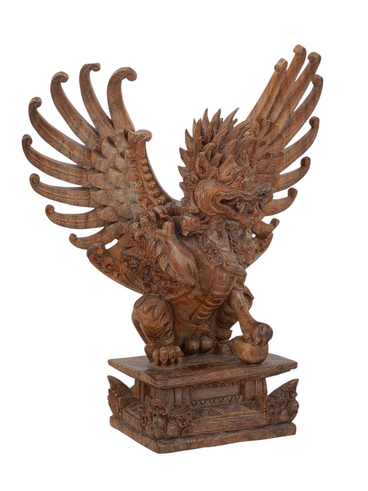 AN INDONESIAN CARVED WOOD MYTHOLOGICAL CREATURE: A highly detailed hand-carved wooden figure of Garuda, the mythological bird-like deity from Hindu and Balinese mythology. Shown in a powerful crouching stance with wings dramatically spread in a fan-