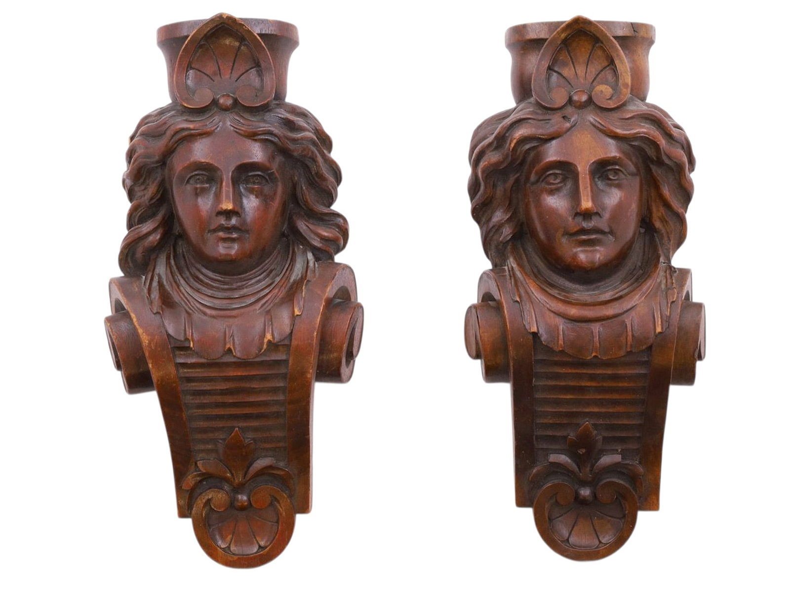 A PAIR OF CARVED WOOD CORBEL BRACKETS WITH FIGURAL HEADS, PROBABLY BLACK FOREST, GERMAN, 19TH: Each carved in hardwood as a Renaissance Revival style bracket, formed with a carved head above a scrolling support terminating in stylized foliate ornament. The faces carved in high relief with flowi