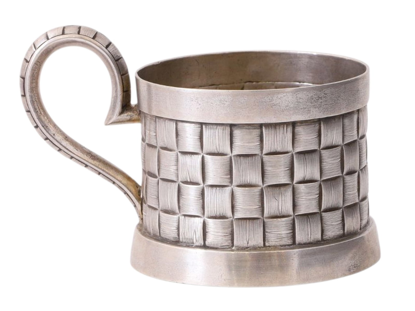 A RUSSIAN SILVER TEAGLASS HOLDER WITH BASKETWEAVE PATTERN, IVAN KHLEBNIKOV, 1889: A cylindrical tea glass holder with a rounded handle. The design on the handle and body imitates a birch-bark woven basket, a favorite motif of Russian jewelers in the late 19th and early 20th centuri