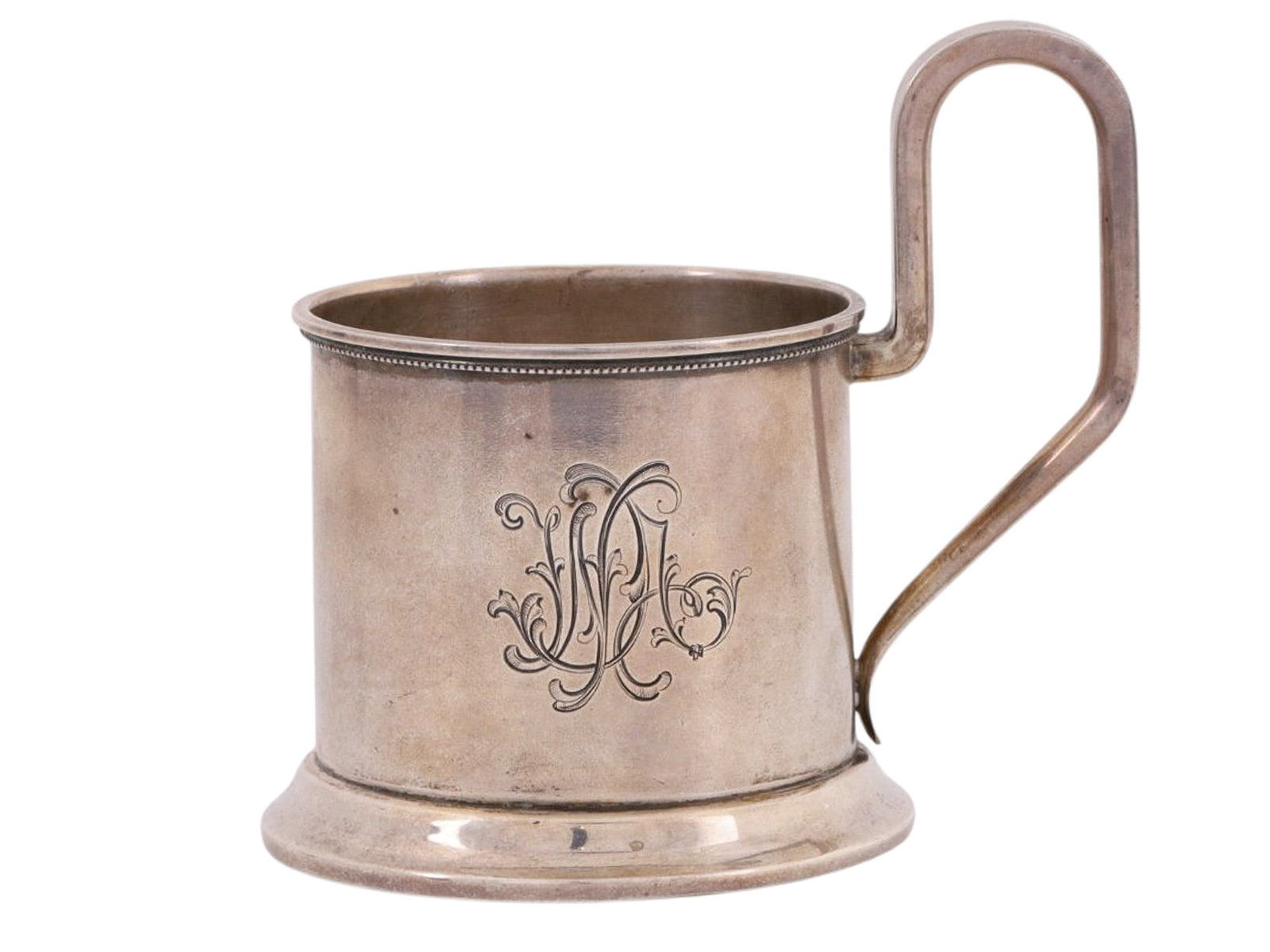 A RUSSIAN SILVER TEA GLASS HOLDER, 19TH CENTURY: A Russian silver podstakannik (tea glass holder), of conventional form, engraved with a monogram on the front, the rim with delicate beaded decoration.Hallmarks: 84 silver proof with kokoshnik.Weight: