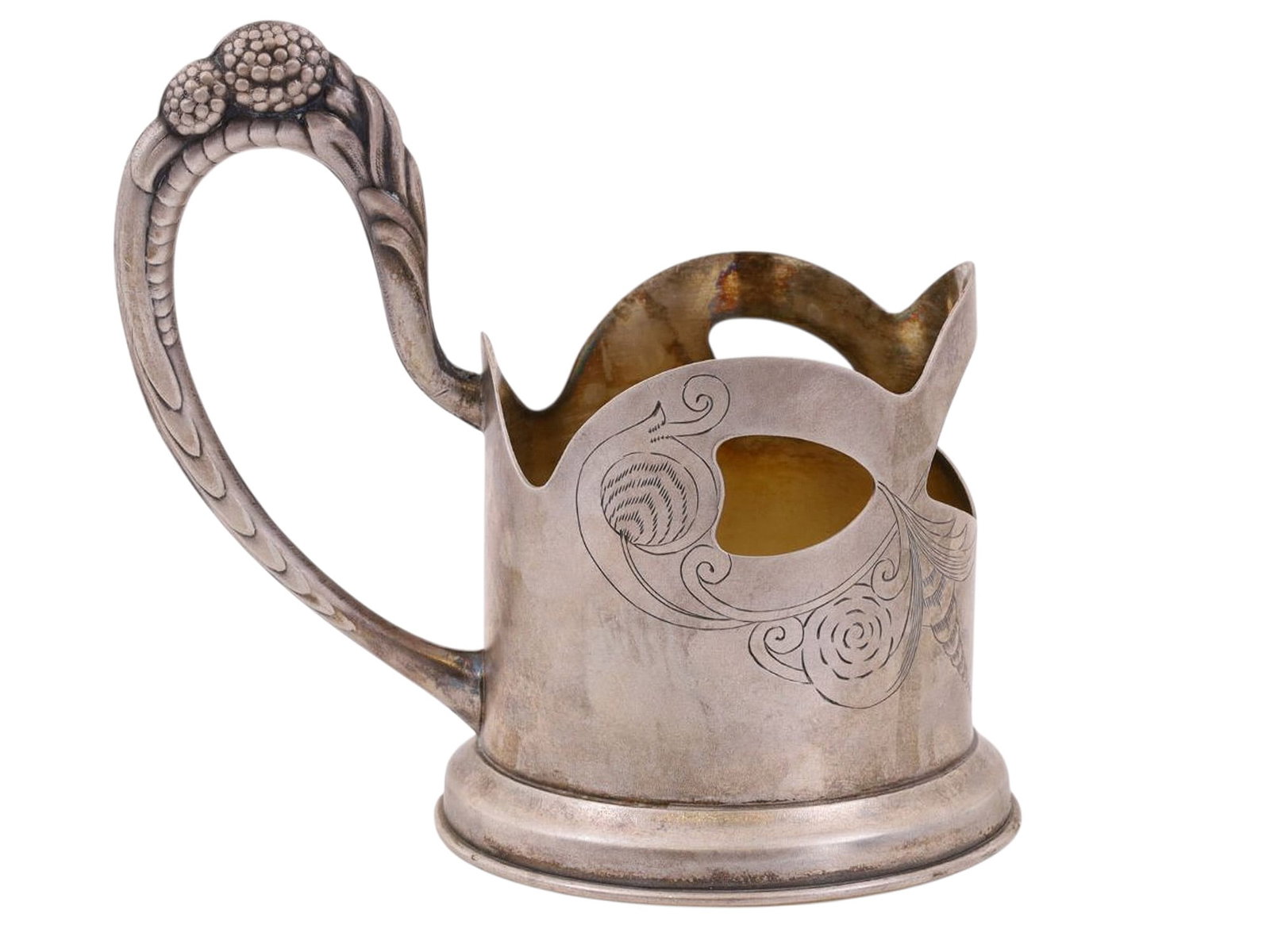 A RUSSIAN ART NOUVEAU SILVER TEAGLASS HOLDER: Of cylindrical form with a curved handle cast with a raised floral ornament in a stylized Art Nouveau manner. The body is decorated with pierced and engraved vegetal motifs, combining openwork and lin