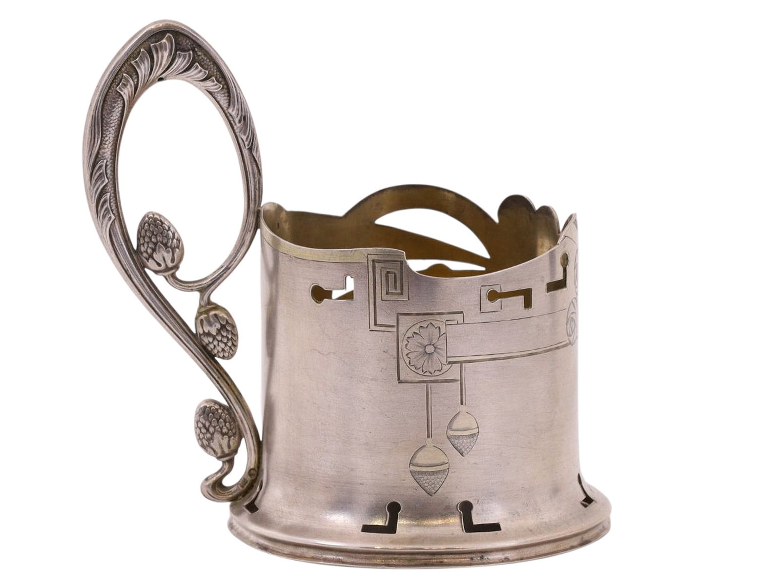 A RUSSIAN ART NOUVEAU SILVER TEAGLASS HOLDER: A Russian podstakannik (tea glass holder) rendered in the art-nouveau style popular at the end of the 19th century, with engraved forms and pierced sections, and a stylized, curved handle rendered a p