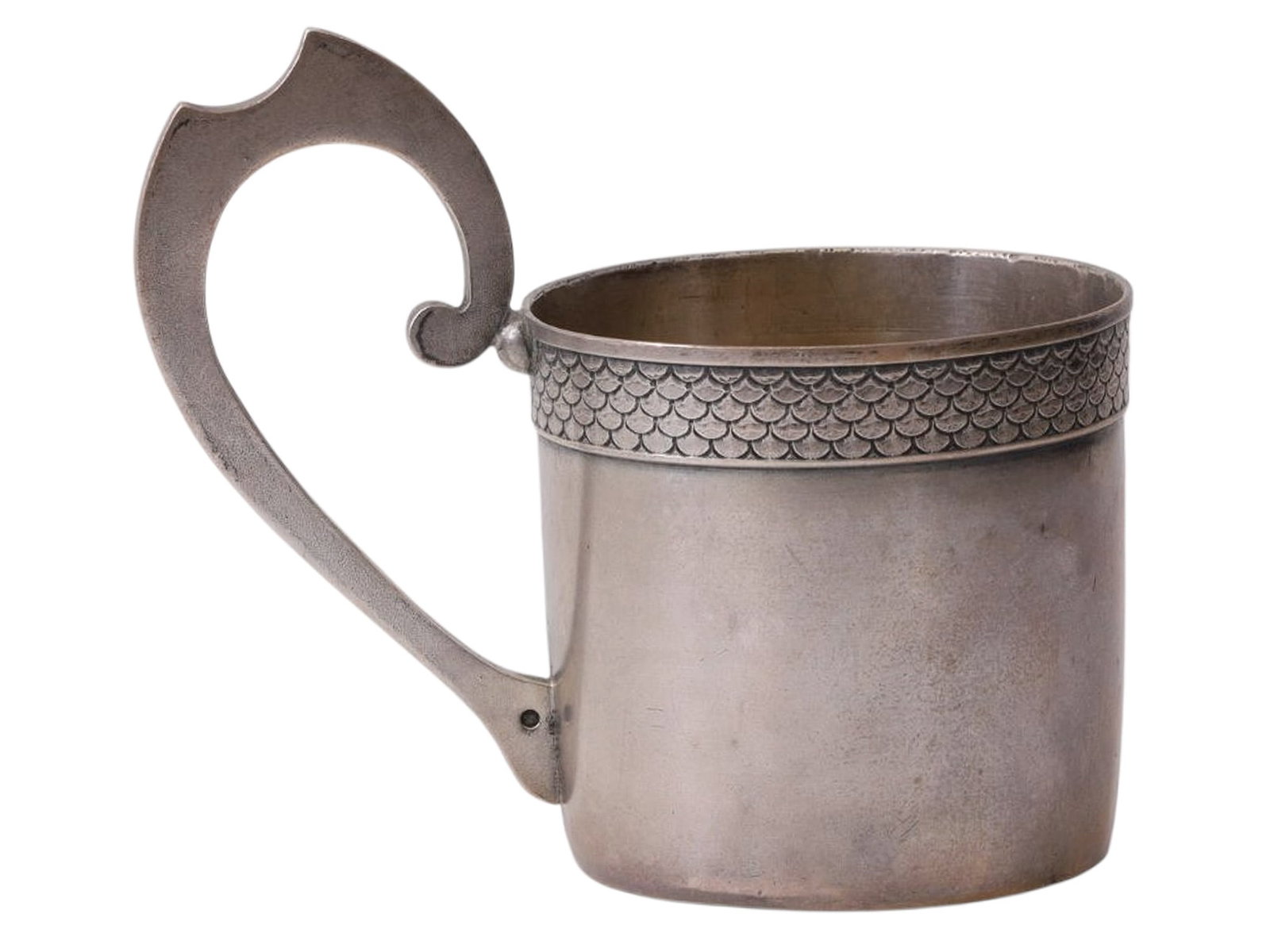 A RUSSIAN SILVER TEAGLASS HOLDER, MOSCOW, 19TH CENTURY: A cylindrical tea glass holder with a flat handle featuring a notch along the upper edge; the upper rim is decorated with a scaly ornamental frieze.There are hallmarks at the base of the handle and on