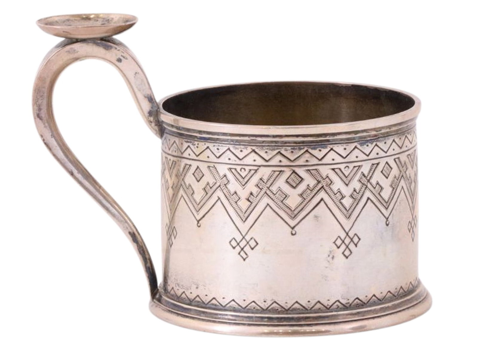 A RUSSIAN SILVER TEAGLASS HOLDER IN PAN-SLAVIC STYLE, 1876: A Russian silver tea glass holder which has been engraved with geometric patterns in the Pan-Slavic style. A thumb grip is affixed to the small curved handle.Hallmarks: 84 silver proof with 'MA' assay