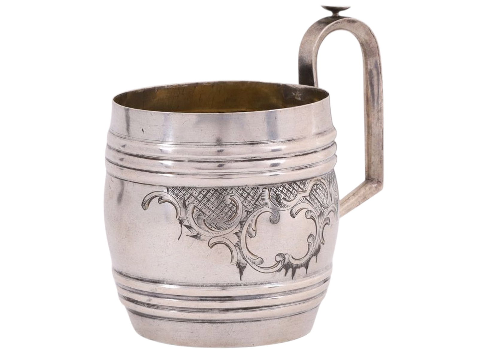 A RUSSIAN SILVER TEAGLASS HOLDER, UNKNOWN PRIVATE WORKSHOP, MOSCOW, LATE 19TH CENTURY: Of barrel form with a rounded handle incorporating a thumb rest. The body engraved on one side with a rocaille composition forming an asymmetrical cartouche, left uninscribed. The compact proportions 