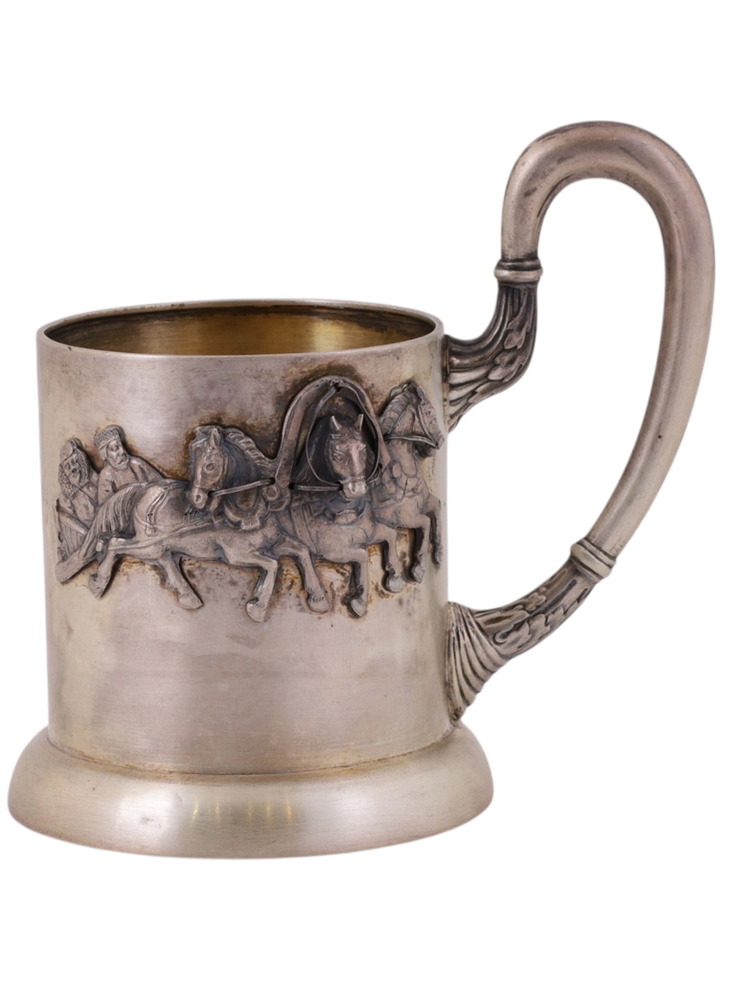 A RUSSIAN COMMEMORATIVE SILVER TEAGLASS HOLDER WITH TROIKA SCENE: Of cylindrical form on a stepped circular foot, the body applied with a finely cast and chased relief frieze depicting a troika with driver and passengers in motion, rendered in high relief with caref