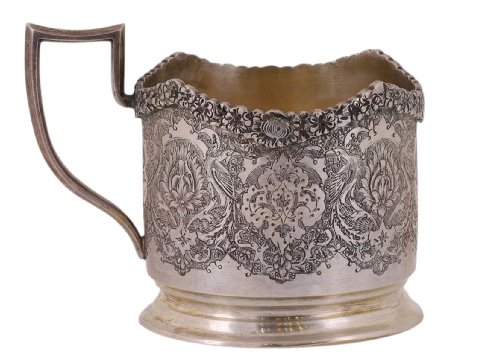 AN INTRICATELY ENGRAVED SOVIET RUSSIAN SILVER TEA GLASS HOLDER: A Soviet Russian silver tea glass holder with extremely intricate engraved decoration in brilliant floral patterns, the rim being encrusted with a garland of flowers as well.Hallmarks: 'DJ84', Soviet 