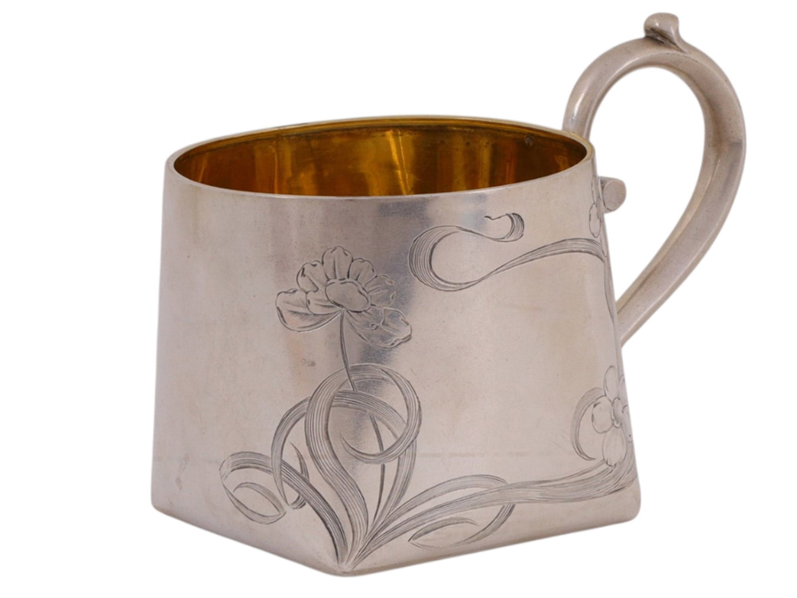 A RUSSIAN PARCEL-GILT SILVER TEA GLASS HOLDER IN ART-NOUVEAU STYLE: A Russian silver podstakannik (tea glass holder) with its body delicately engraved with floral decoration in the art-nouveau style. The body with a square base which tapers into a circular rim. The in