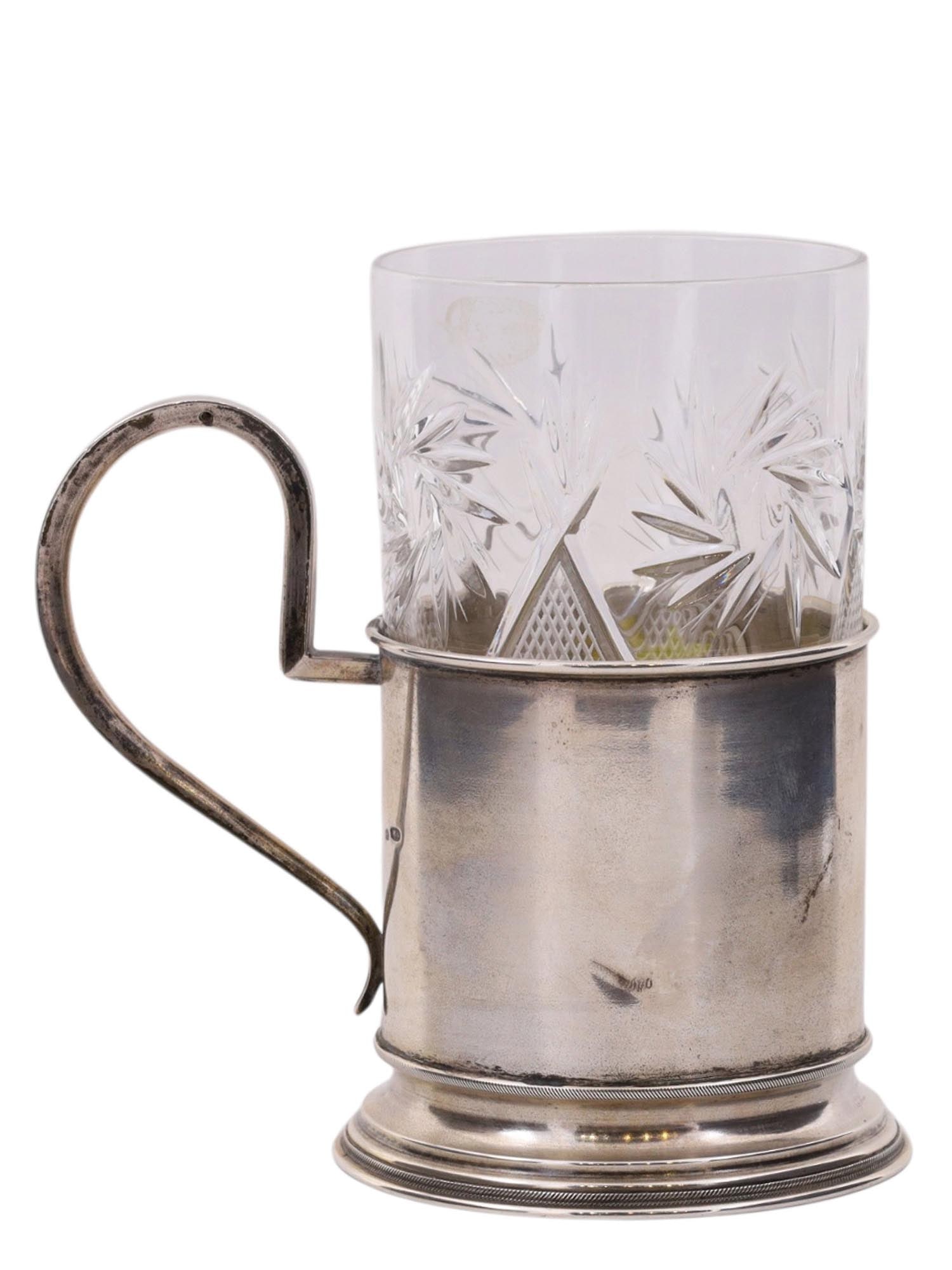 A RUSSIAN ENGRAVED SILVER TEA GLASS HOLDER WITH A CUT CRYSTAL GLASS: A Russian engraved silver tea glass holder with a cut-crystal glass. Made by the workshop of V. Semenov. Marked on the bottom with "VS" in Cyrillic, 84 Russian silver proof.Weight: 4.3 oz., 122 g. Dim