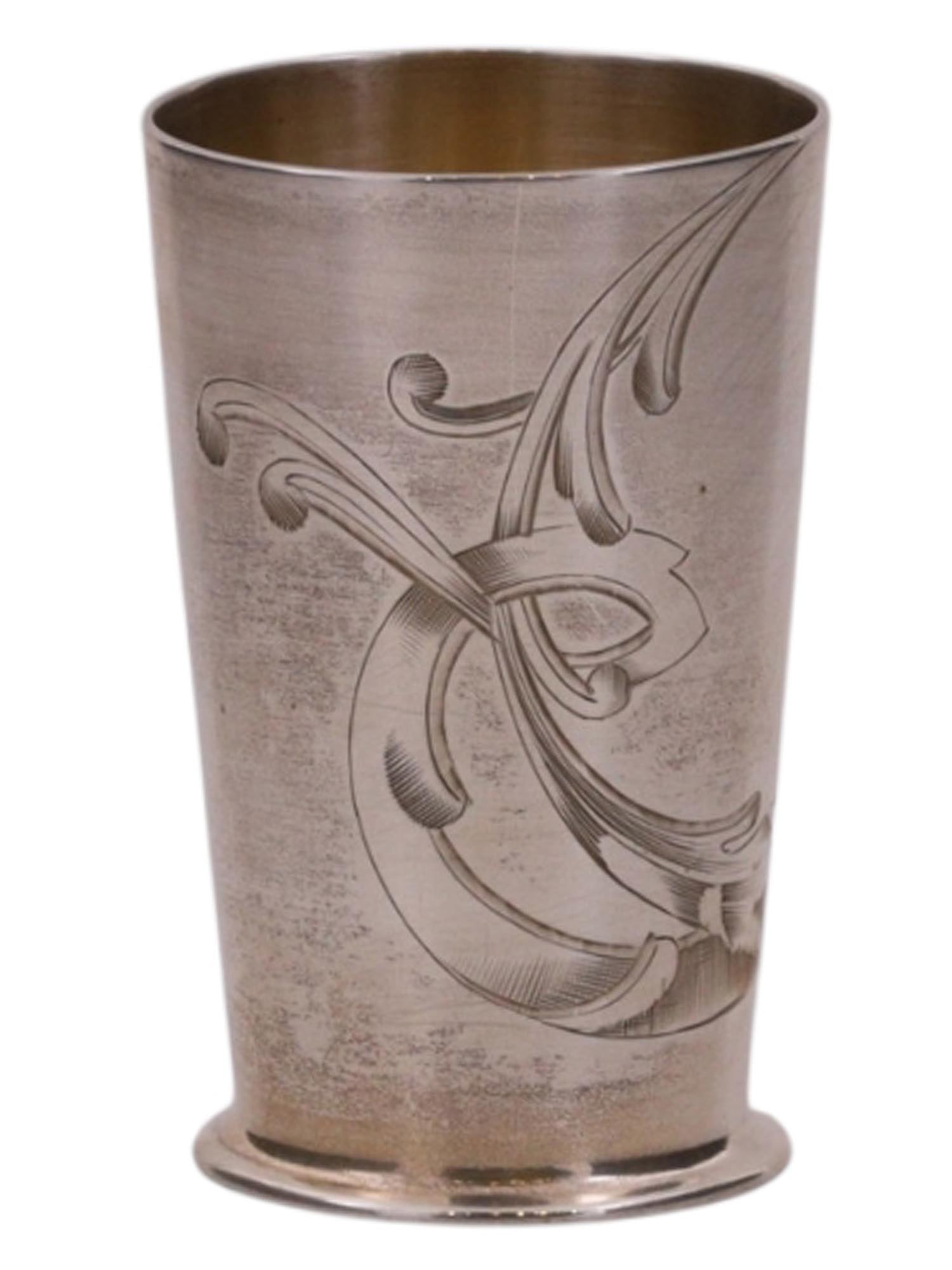A RUSSIAN PARCEL-GILT SILVER SHOT GLASS WITH ENGRAVED DECORATION: A Russian parcel-gilt silver shot glass with its circumference engraved with scrollwork motifs.Hallmarks: 84 silver proof with kokoshnik, partially obscured Cyrillic hallmark that begins with 'P'.Weig