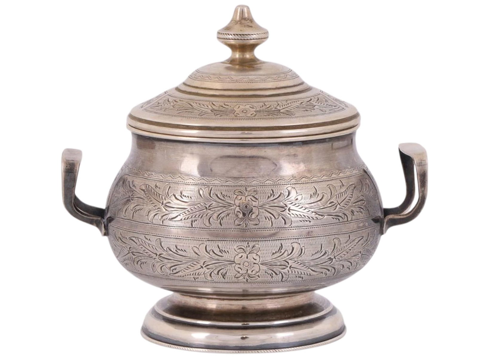 A RUSSIAN PARCEL-GILT SILVER LIDDED SUGAR BOWL, C. 1885: A Russian silver sugar bowl from the end of the 19th century, delicately engraved with floral imagery against a stippled background. The belly of the bowl affixed with two looped handles, the lid topp