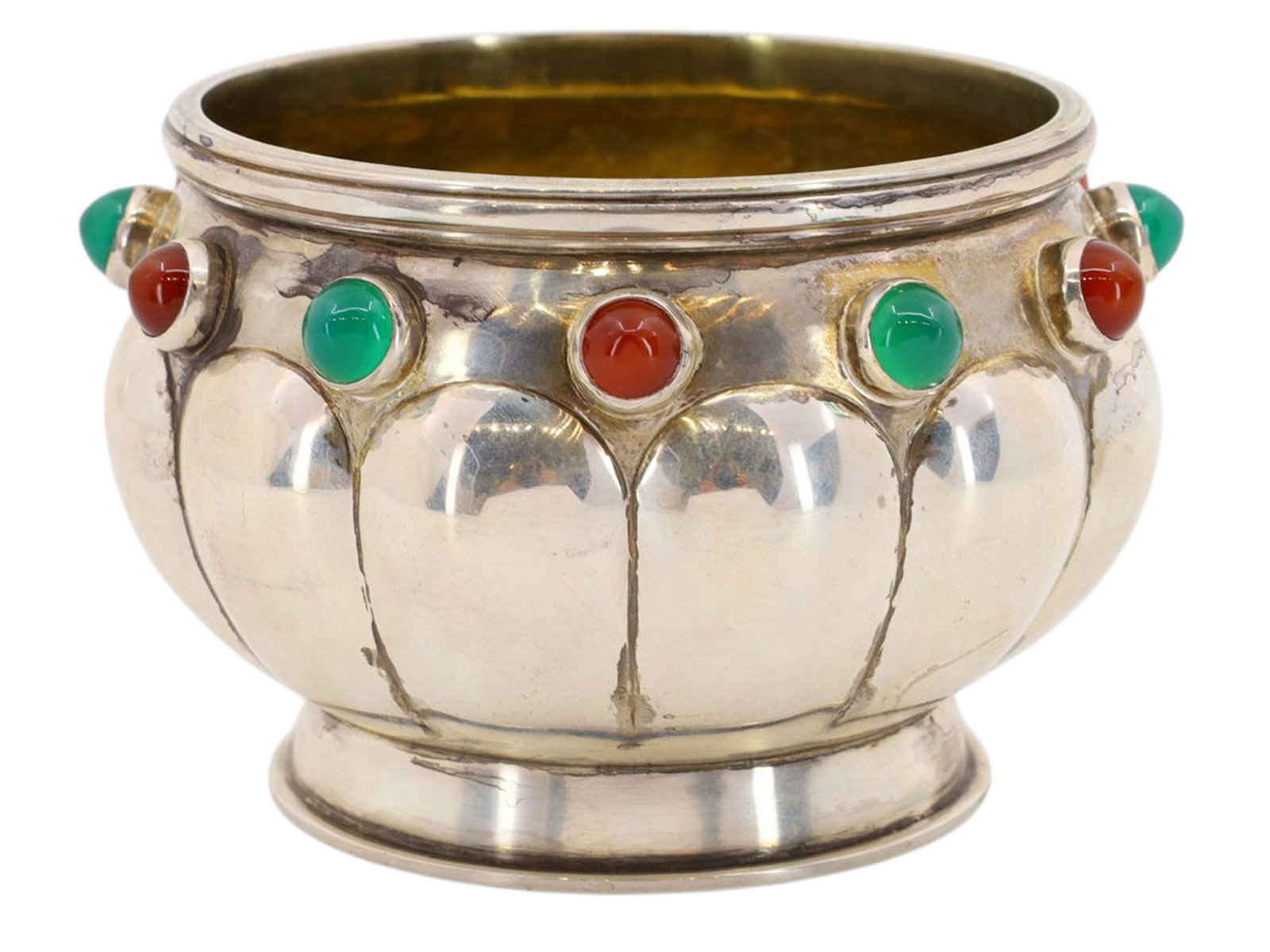 A RUSSIAN PARCEL-GILT SILVER BRATINA WITH CABOCHONS: A Russian parcel-gilt silver bratina (brother cup), set with bright green and red cabochon stones around the rim of its gently lobed body.The underside is marked with the '84' silver proof with kokosh