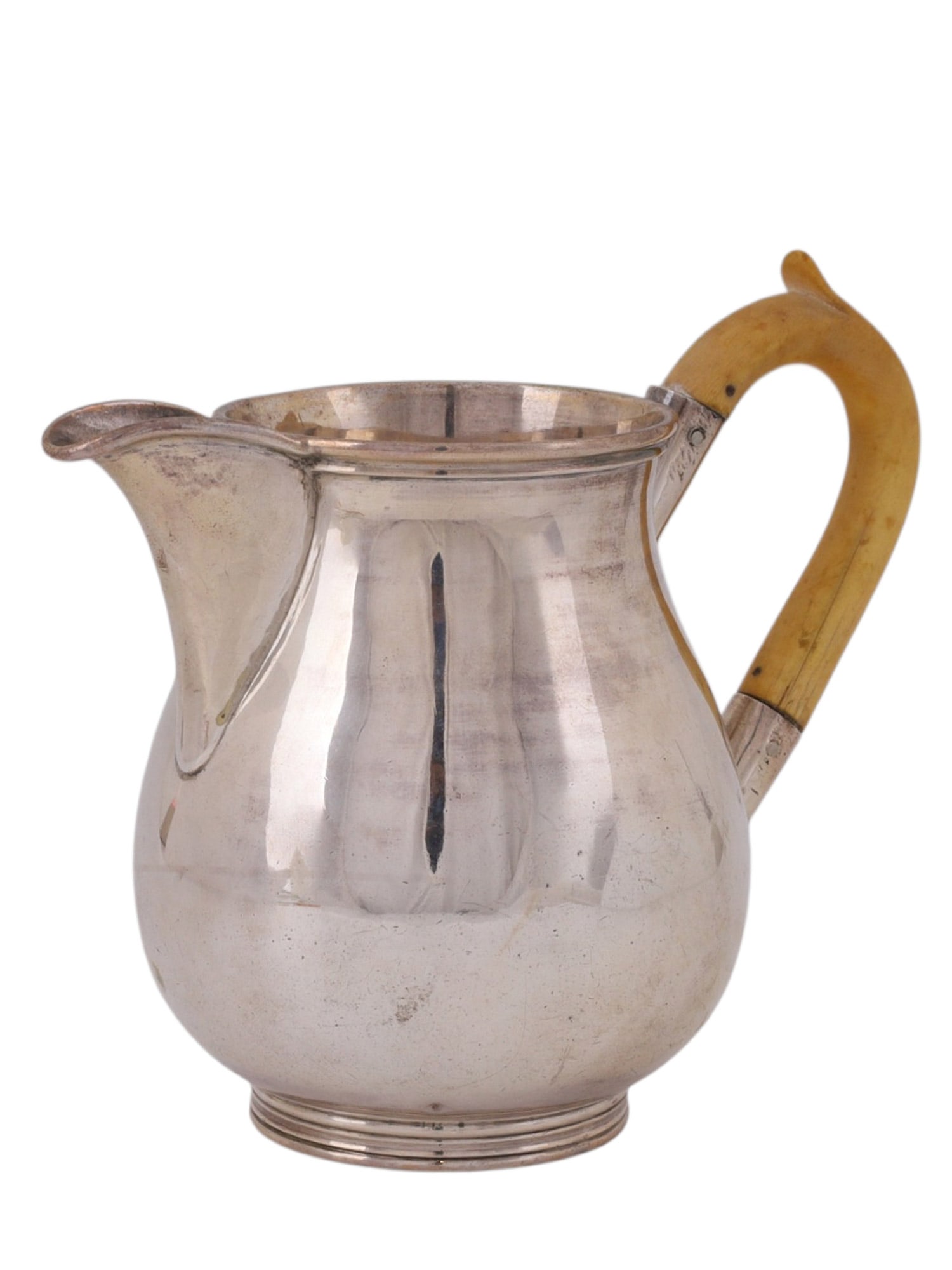 A RUSSIAN SILVER CREAMER WITH IVORY HANDLE, ST. PETERSBURG, 1886: Of baluster form with a gently flared rim and shaped pouring spout, raised on a stepped circular foot, the plain polished body reflecting a restrained late 19th century aesthetic. The handle of curved