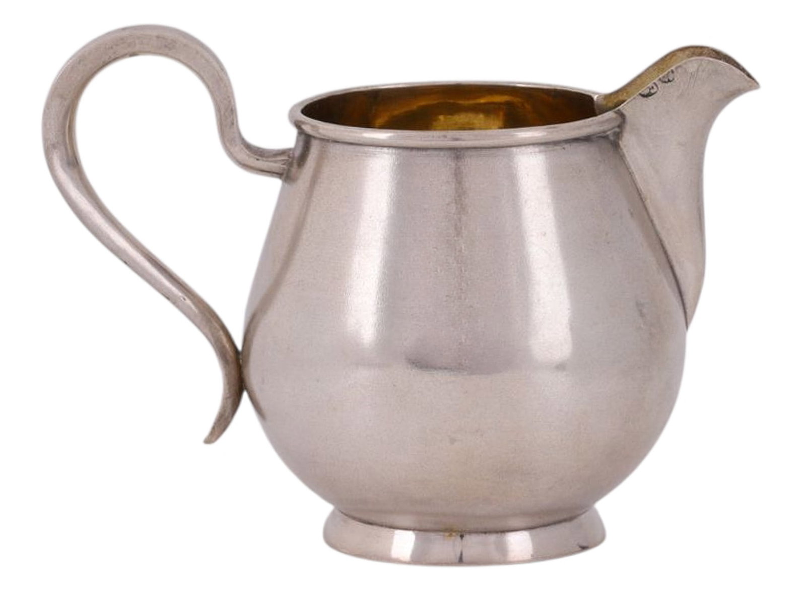 A RUSSIAN PARCEL-GILT SILVER CREAMER, SERGEI FROLOV WORKSHOP, C. 1880S: A classic-style creamer jug without decoration, featuring a curved handle. Gilded on the inside.The body, handle, and base bear hallmarks: the Moscow assay mark in an oval shield with notches “8