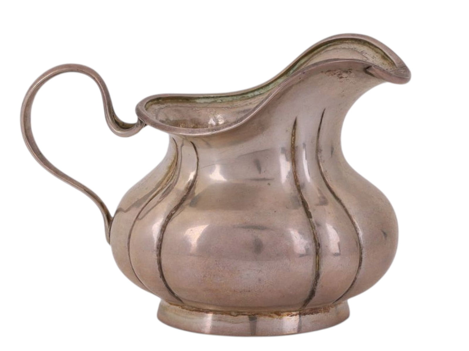 A RUSSIAN SILVER CREAMER, ANDREY VEKMAN WORKSHOP, MOSCOW, 1864: A pear-shaped/bulbous creamer with a wavy rim and an S-shaped handle, without decoration.The handle, lower rim, and base bear the following marks: the assayer’s mark “V.S. 1864,” the