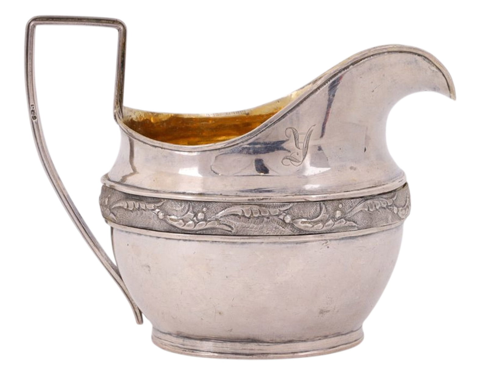 AN EARLY 19TH CENTURY RUSSIAN PARCEL-GILT SILVER CREAMER: An parcel-gilt silver creamer from early 19th century Imperial Russia, produced in the year 1816. The belly of the creamer is decorated with a foliate-patterned band, the inside with a bright parcel-g