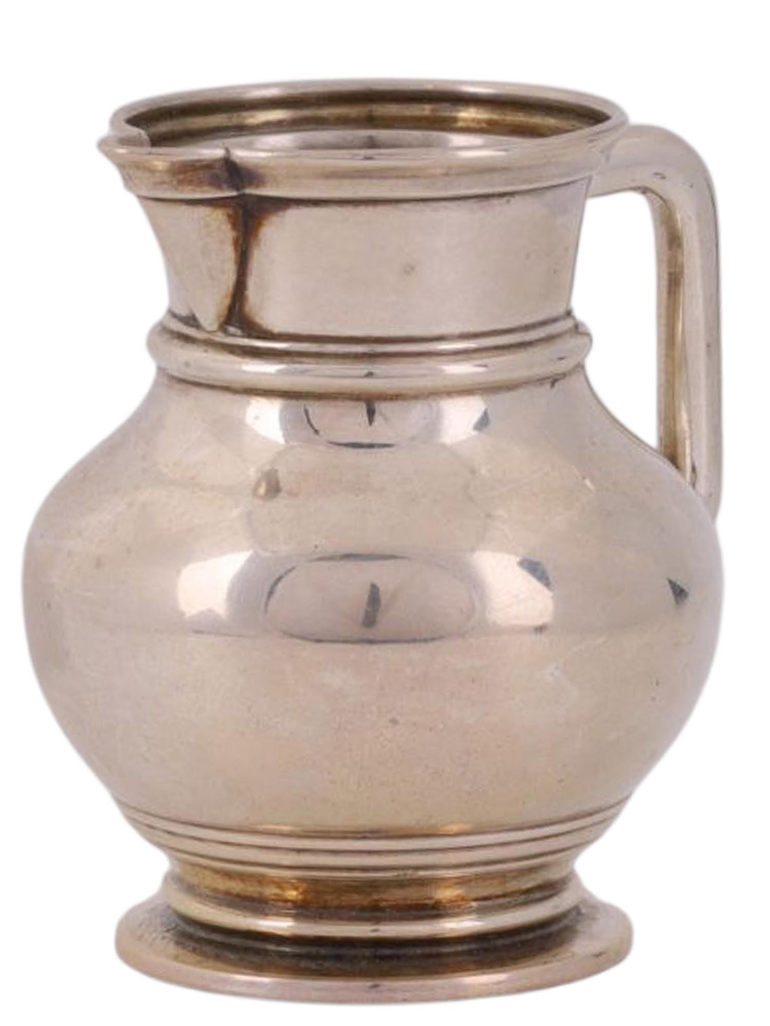 A RUSSIAN SILVER CREAMER, KHLEBNIKOV FACTORY, 1880: A Russian silver creamer produced by the Khlebnikov factory in the year 1880, with a bulbous body and a flared spout. Hallmarks: Imperial Warrant Eagle, Khlebnikov maker's mark, 'E.K' assayer's mark o