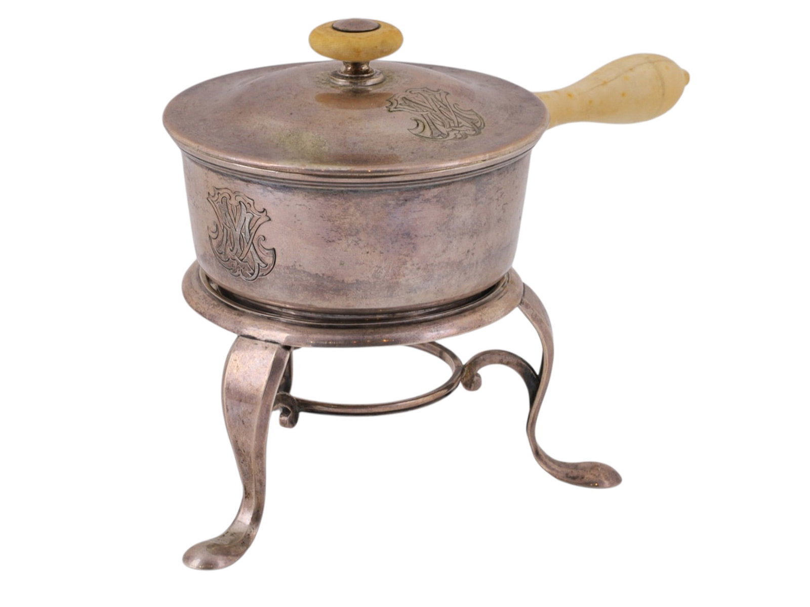 A RUSSIAN SILVER SPIRIT WARMER WITH PAN AND STAND, BY IGNATIY SAZIKOV, ST. PETERSBURG, 1874: In the form of a small lidded saucepan with a turned bone handle and finial, raised on a separate three-footed spirit stand with circular burner support. The body plain and cylindrical with a slightly