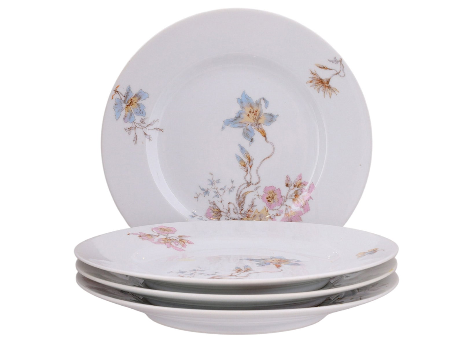 A LOT OF FOUR RUSSIAN PORCELAIN PLATES, KORNILOV BROTHERS, LATE 19TH TO EARLY 20TH CENTURY: Each of circular form decorated on a white ground with painted floral sprays in soft polychrome enamels, including blue blossoms and pink flowers. The compositions are asymmetrically arranged, with ce