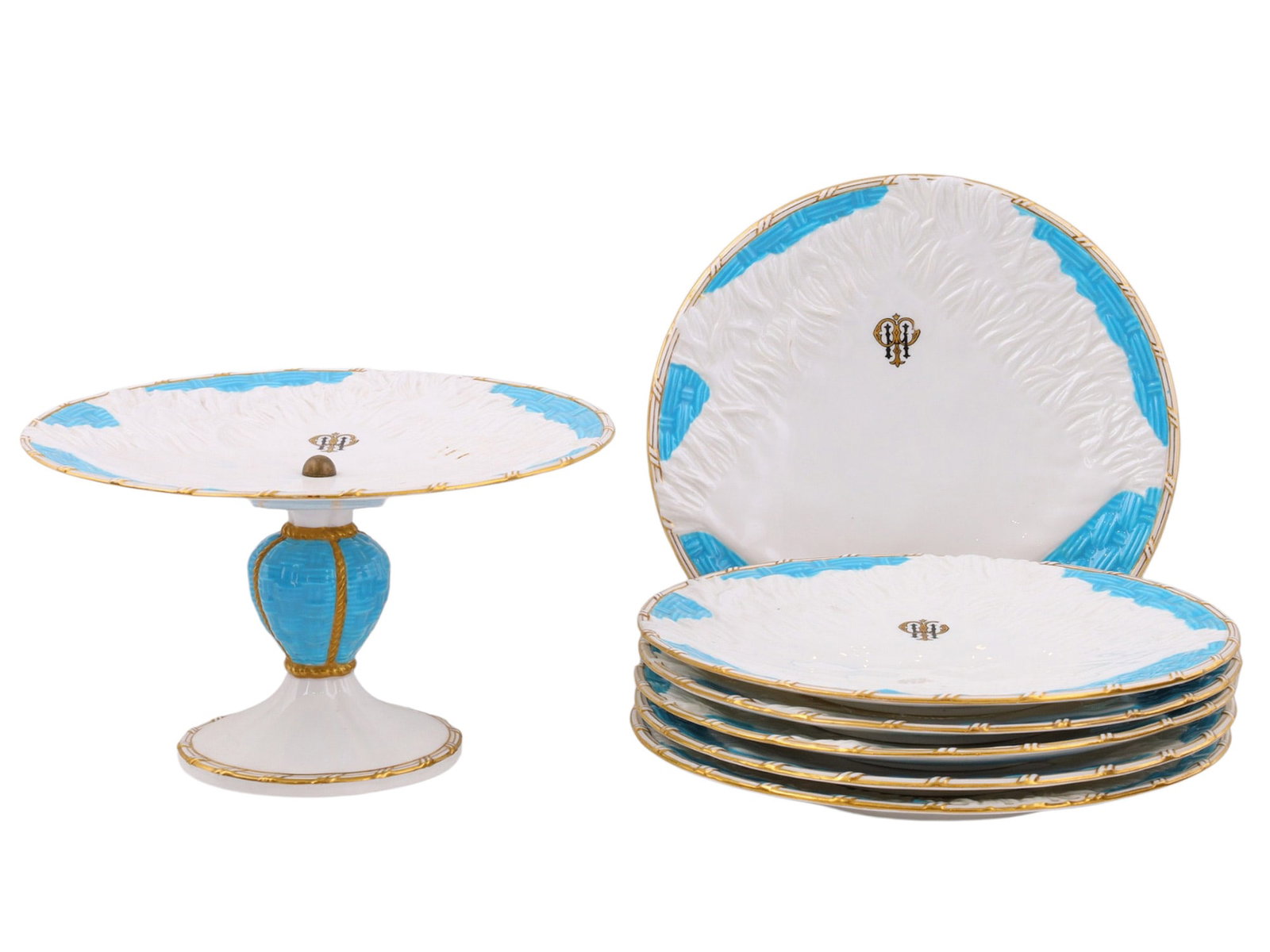 AN ENGLISH MONOGRAMMED PORCELAIN SEVEN-PIECE SERVICE SET, 19TH CENTURY: Comprising a pedestal compot and six plates, each with a molded foliate border highlighted with turquoise panels and gilt decoration, the centers with a gilt monogram. The compot is raised on a balust