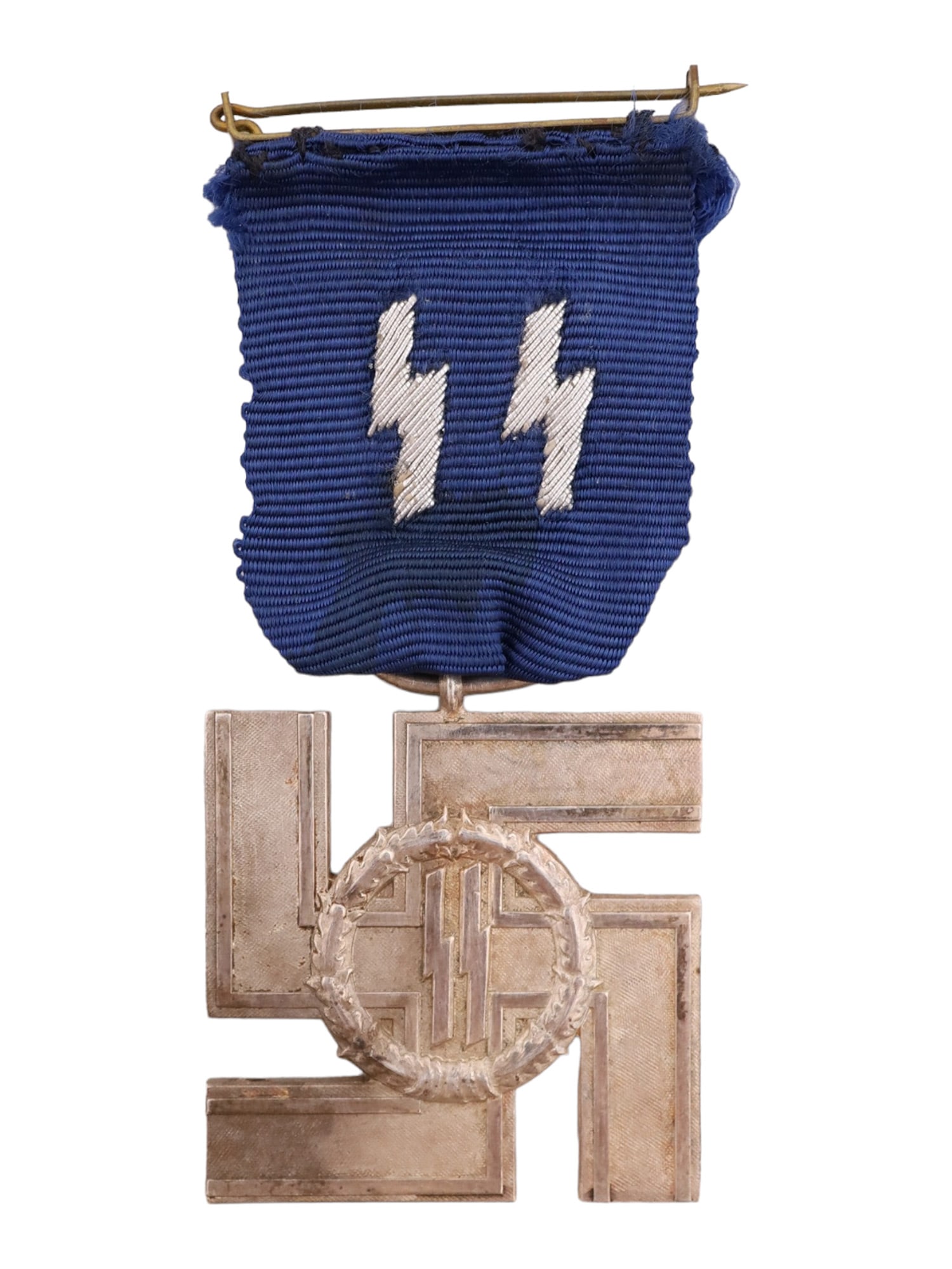 A GERMAN 12-YEAR SS LONG SERVICE MEDAL WITH RIBBON WW2: A rare silver medal for 12 Years of Service in the SS. Executed in silver a swastika on a blue moire ribbon with embroidered silver SS runes. Zig-runes enclosed in an oak wreath are superimposed on th