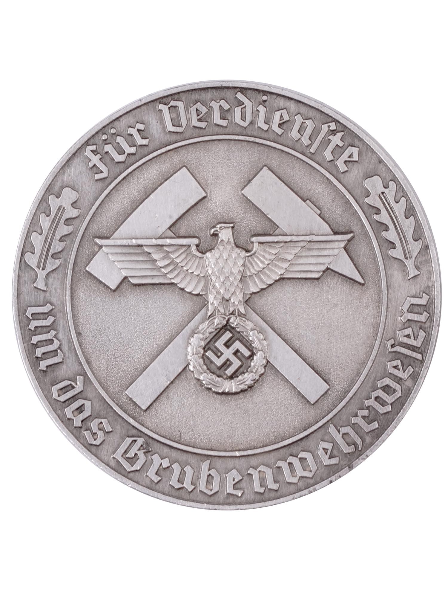 A WW2 GERMAN MEDAL FOR MINE RESCUE, THIRD REICH: MEDAL FOR MINE RESCUE (Grubenwehr-Ehrenzeichen) of silvered bronze, the ribbon is missing. The obverse depicts crossed pickaxes, overlaid by a raised NSDAP-style German national eagle clutching a wrea