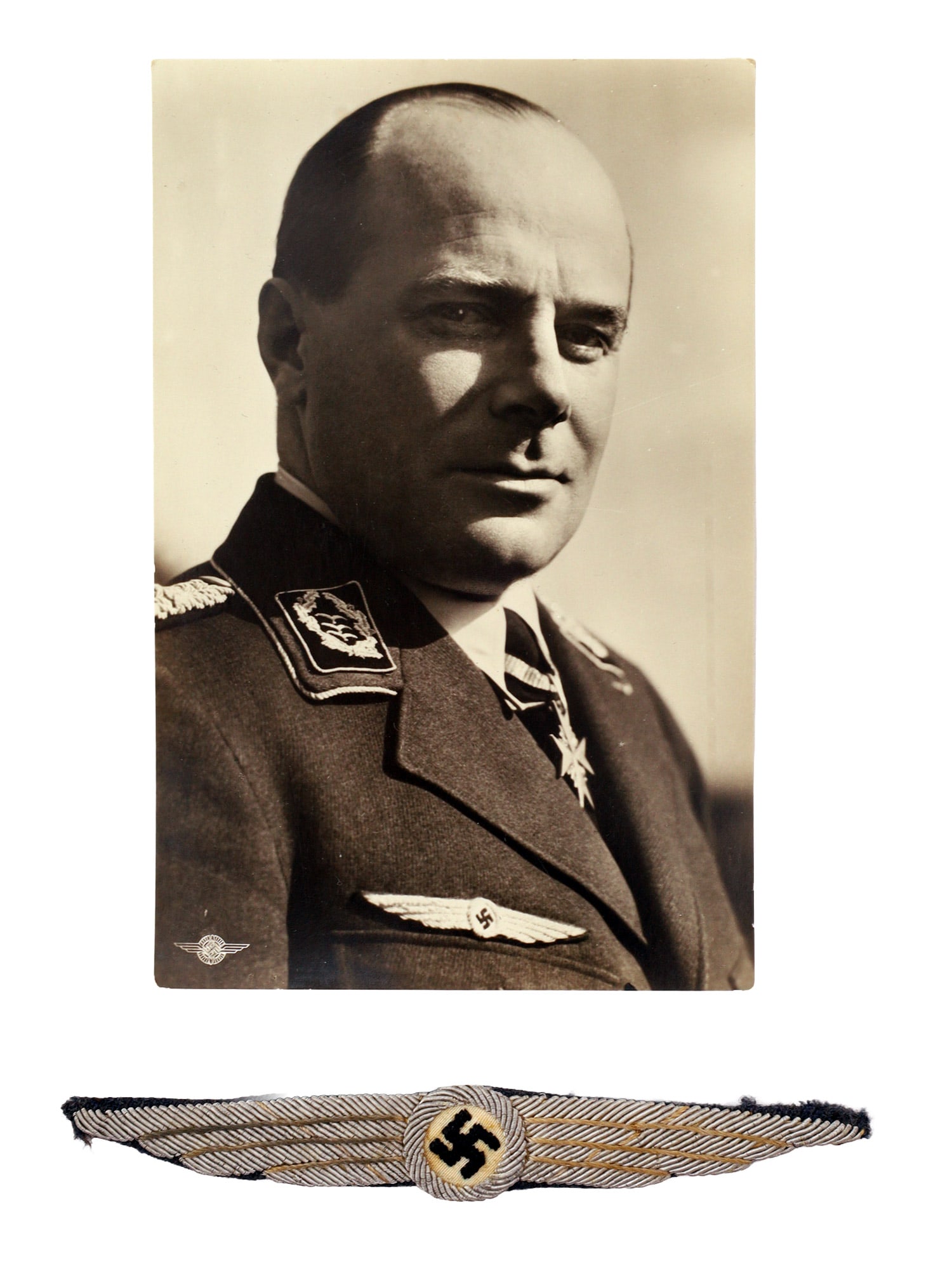 A GERMAN 3RD REICH DLV BULLION PILOT?S BADGE ACCOMPANIED WITH ERNST UDET PHOTO / POSTCARD: A Third Reich period group comprising an original portrait postcard depicting Flieger-Kommodore Ernst Udet in NSFK uniform together with a bullion embroidered Nationalsozialistisches Fliegerkorps (NSF