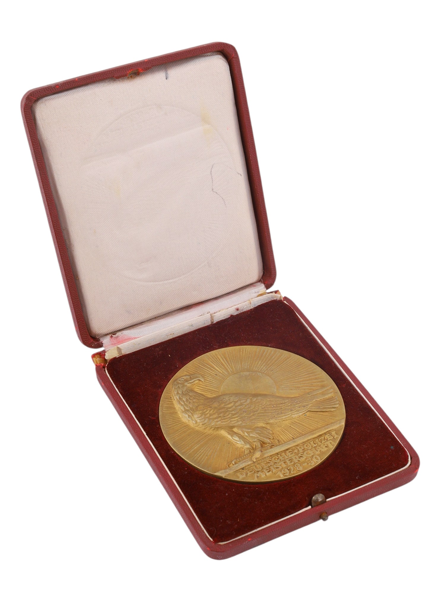 A CASED GERMAN NATIONAL POLICE CHAMPIONSHIP COMMEMORATIVE MEDAL, 1928?1930: The lot comprises a large gilt bronze commemorative medal housed in its original fitted presentation case. The obverse depicts an eagle standing before a radiant rising sun above the inscription "Deut