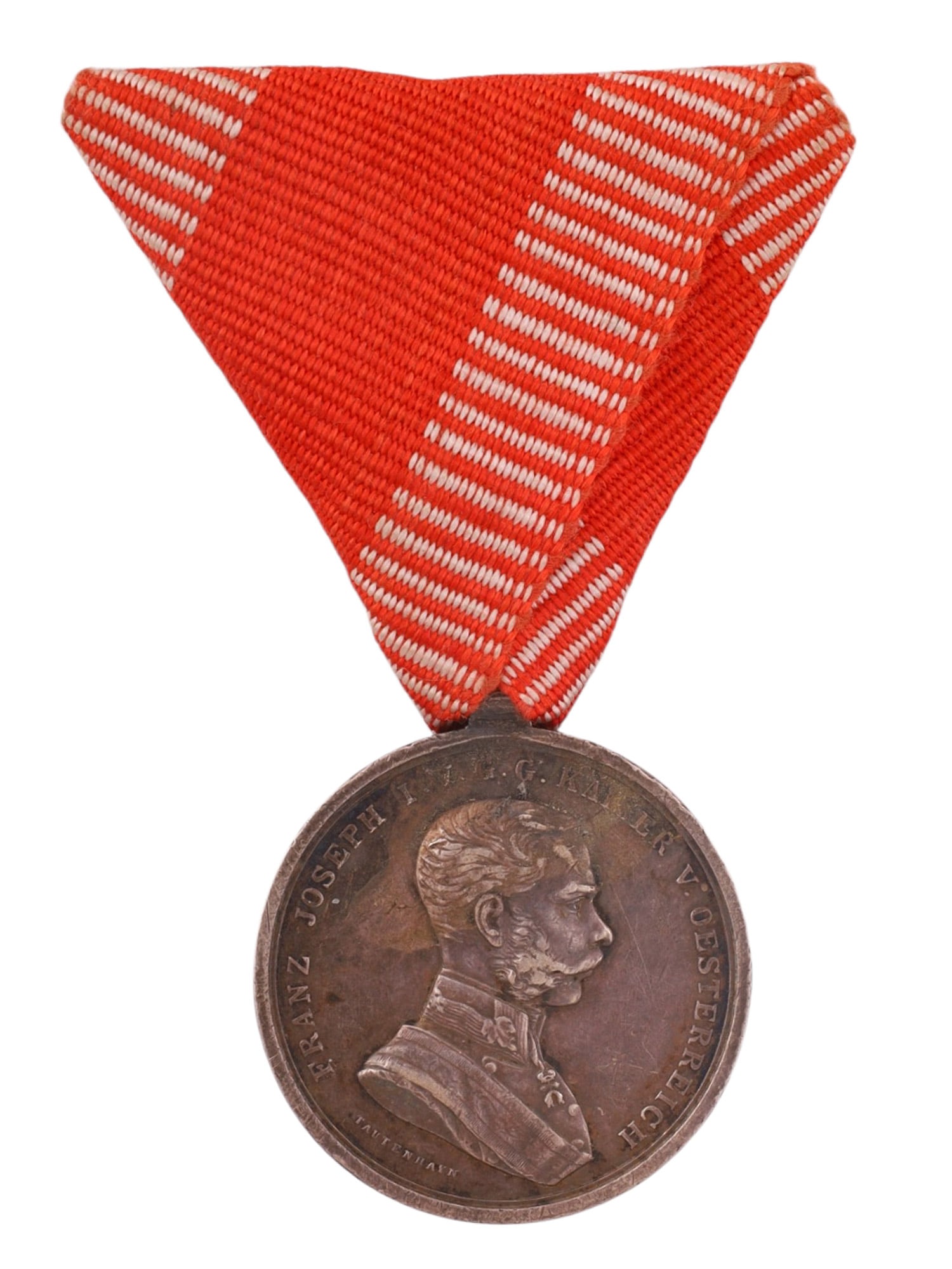 AN AUSTRIAN BRAVERY MEDAL (TAPFERKEITSMEDAILLE), FRANZ JOSEPH I, BRONZE CLASS: Circular bronze medal issued during the reign of Emperor Franz Joseph I of Austria. The obverse bears a right-facing portrait of the emperor with the surrounding legend "Franz Joseph I. G. G. Kaiser v