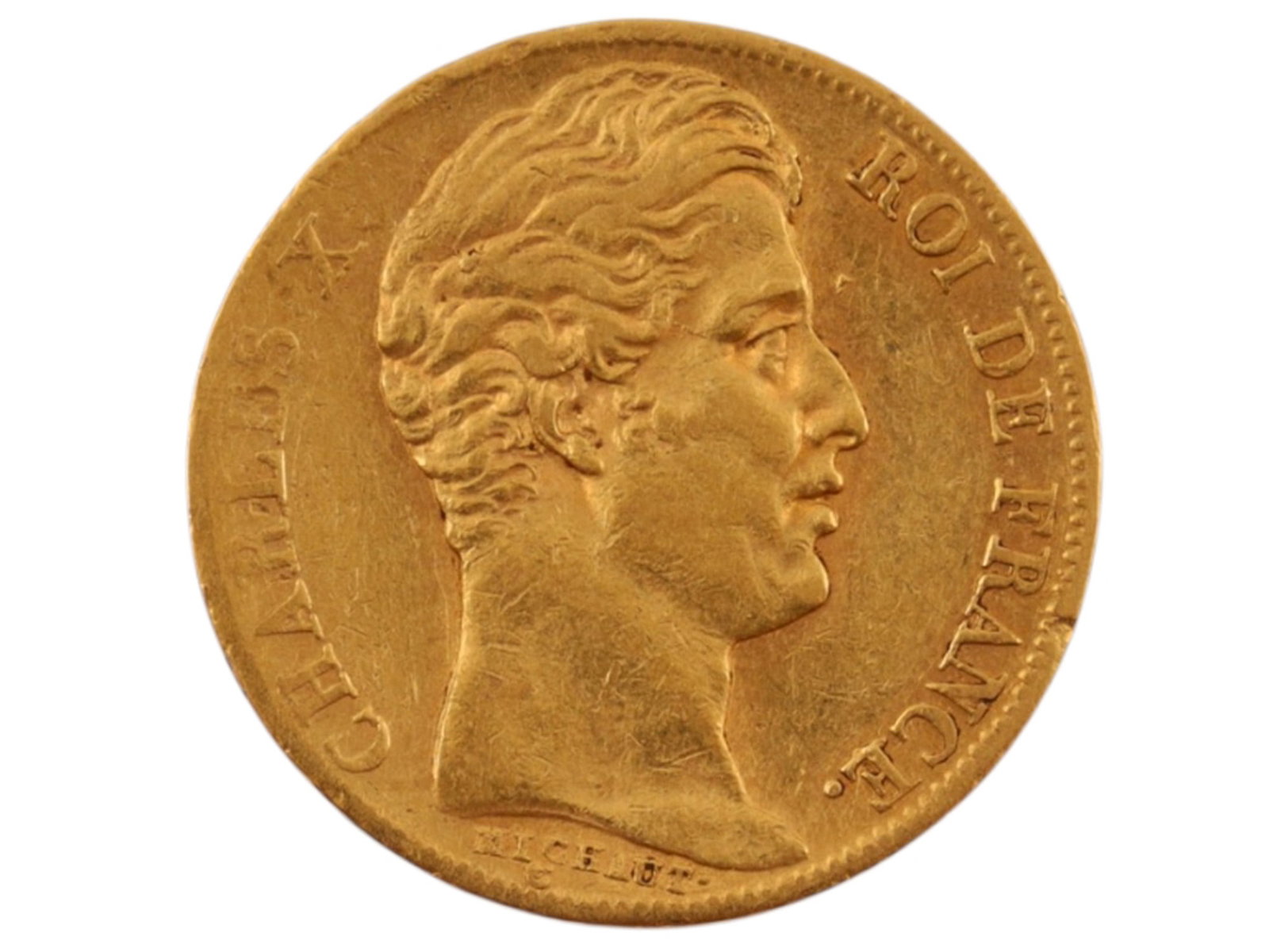 AN 1830 20 FRANCS CHARLES X COIN, KINGDOM OF FRANCE: A French 20 Franc coin from the Kingdom of France produced in 1830 during the reign of Charles X, displaying his face to one side and the French coat of arms to the other. The edge of the coin is stam