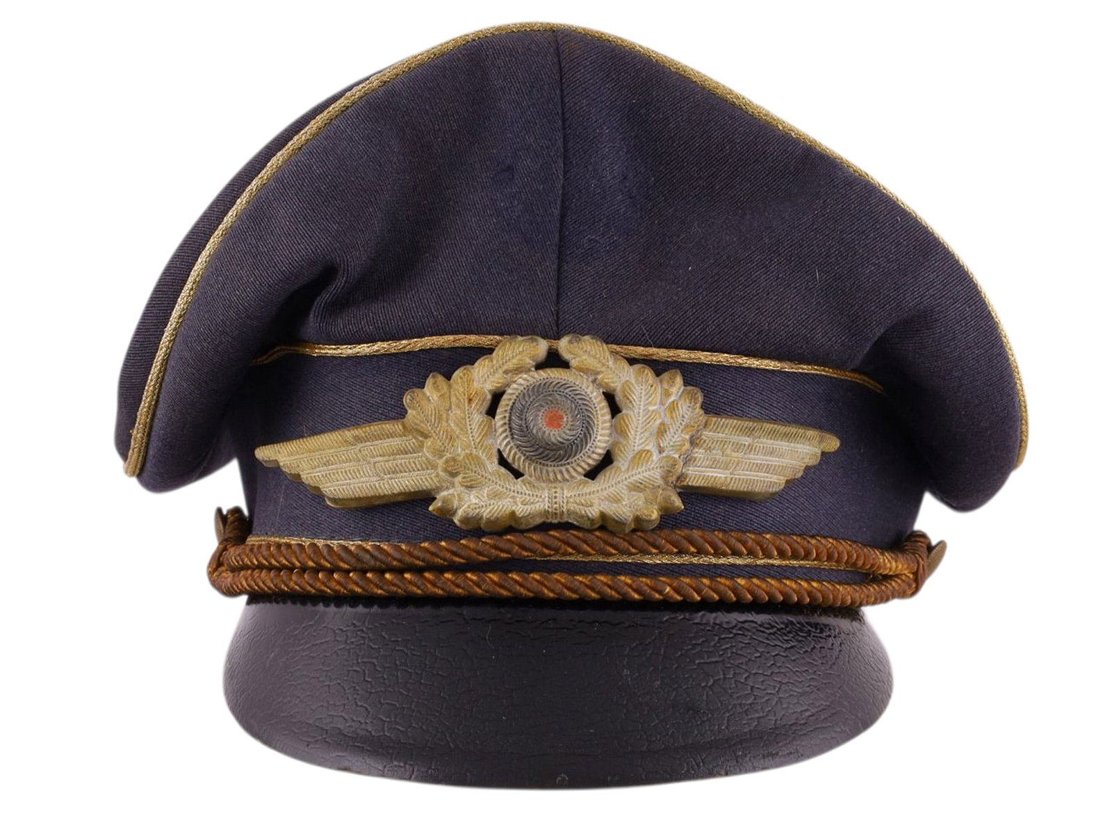 A LUFTWAFFE OFFICER?S VISOR CAP (SCHIRMM?TZE), WWII GERMANY, NAMED TO MICHAEL B?RHEL: Constructed of blue-gray wool with gold piping and black visor, fitted with gilt metal Luftwaffe eagle, oak leaf wreath, and national cockade, with brown twisted officer’s chin cord. The interio