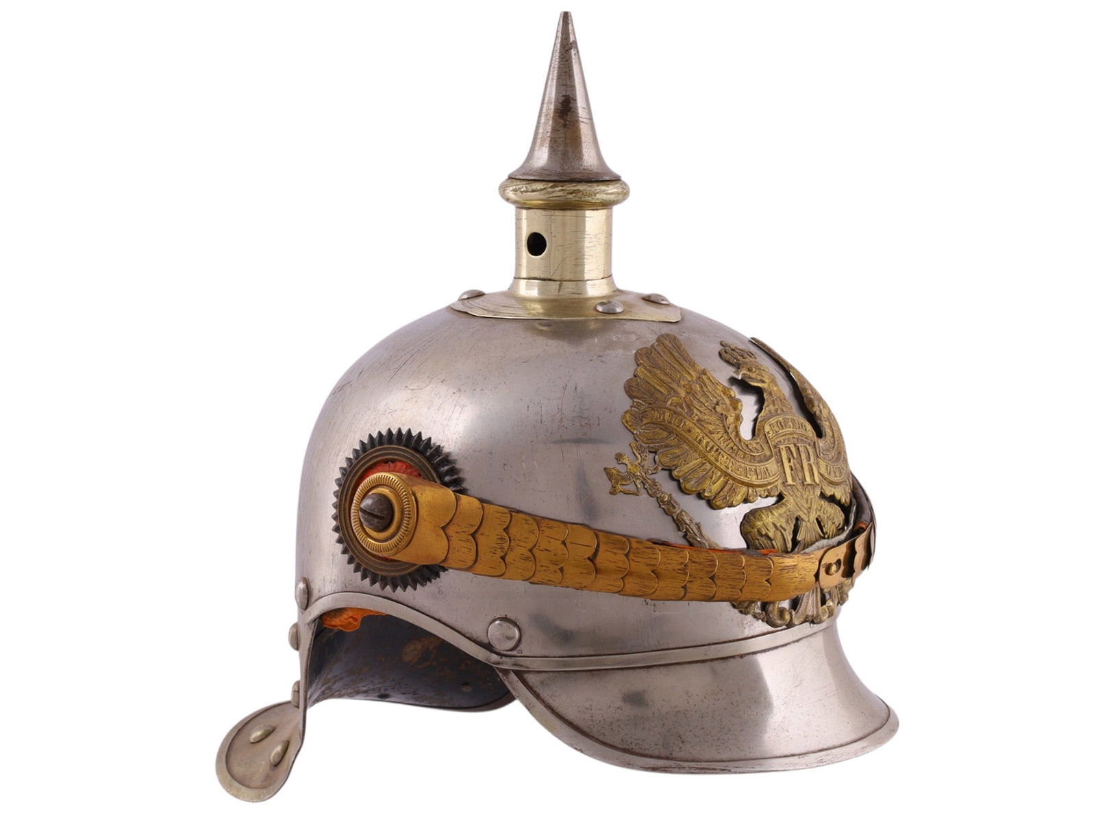 A PRUSSIAN CUIRASSIER HELMET, IMPERIAL GERMANY, CIRCA 1895-1914: Of traditional heavy cavalry form, the helmet is constructed with a polished steel skull surmounted by a detachable spike on a brass mount. The front is applied with a gilt-brass Prussian eagle plate 