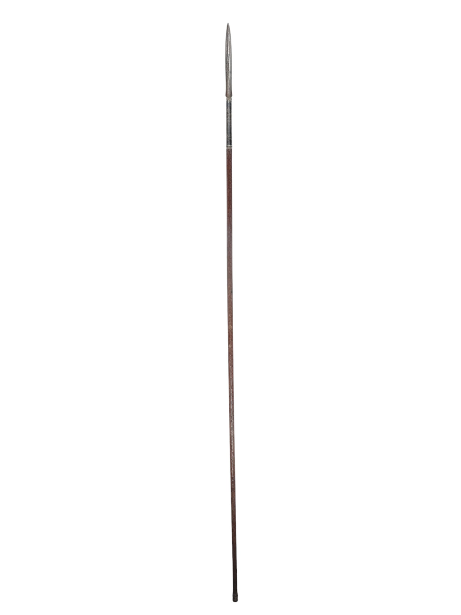 AN INDONESIAN TOMBOK SPEAR, JAVA OR BORNEO, 19 C.: Spear from Java (called “Tombok”) or Borneo. Dark brown haft with ring striped decoration during its long. No decoration on the thin blade, long dark colored socket, bead molding ferrule. 