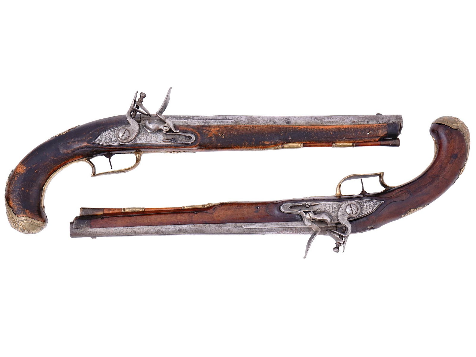 A MATCHED PAIR OF EUROPEAN FLINTLOCK PISTOLS, PROBABLY CENTRAL OR NORTHERN EUROPE, MID?LATE 18TH: Each pistol of classic mid-18th-century civilian or officer’s form, fitted with octagonal-to-round steel barrels engraved at the breech with scrolling foliage and linear borders. The lockplates 