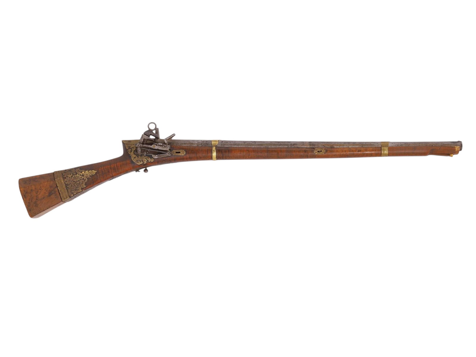 AN OTTOMAN TURKISH TUFEK RIFLE WITH INTRICATE BRASS OVERLAY, 19TH CENTURY: A finely crafted Ottoman Turkish tufek rifle with an octagonal barrel containing a heptagonal bore, the stock of wood which has been set with intricate openwork brass overlay in floral patterning thro