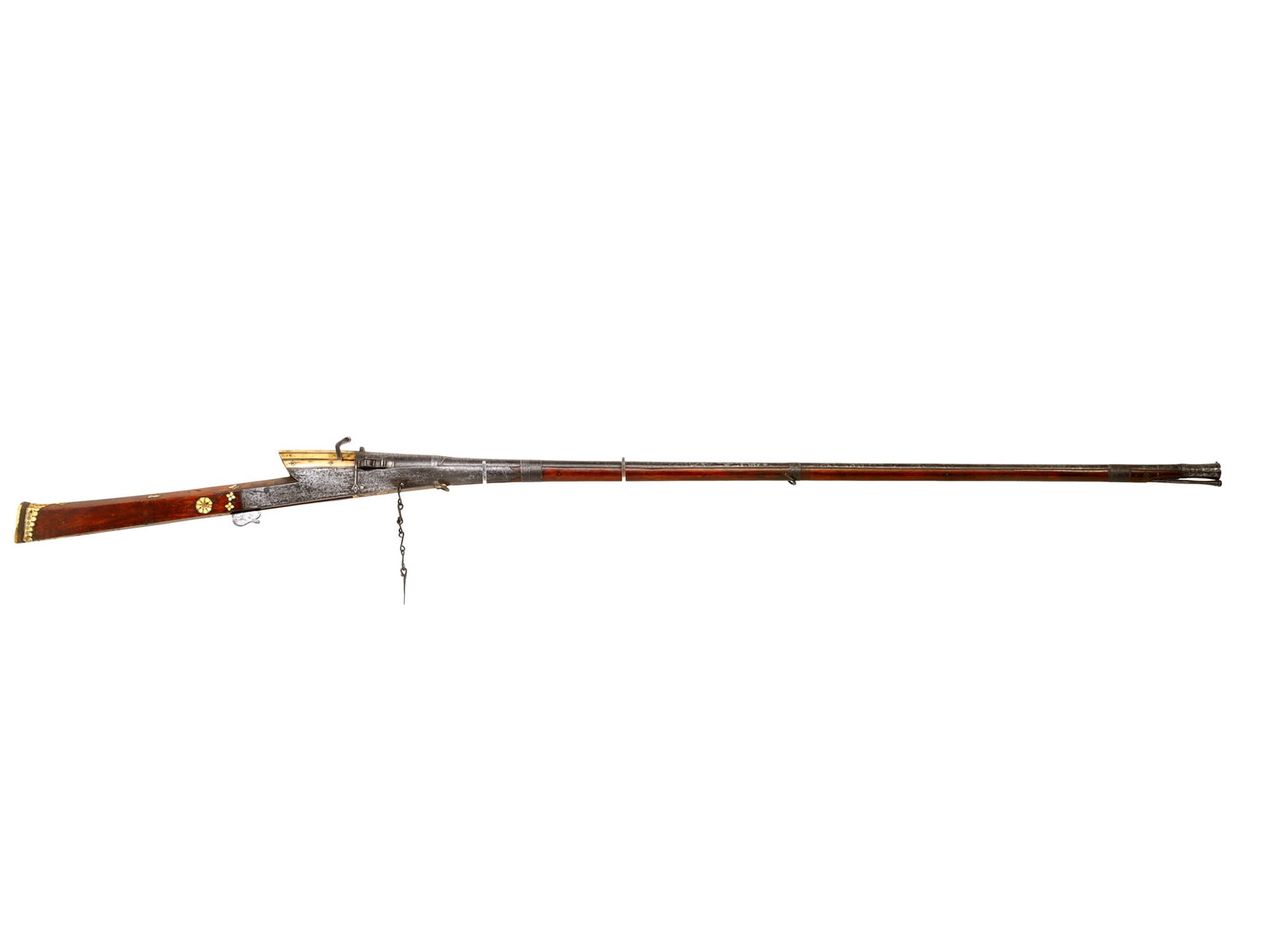 AN INDIAN MATCHLOCK TORADAR RIFLE, TWISTED STEEL BARREL, 18TH CENTURY: A Toradar matchlock rifle with a long twisted steel barrel ending in a flared muzzle, the breech decorated with a large, chased floral motif. The wooden stock is set with bone inserts and hung with tw