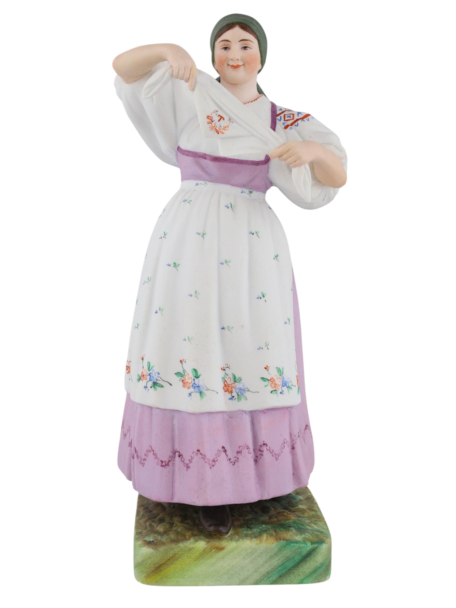 A RUSSIAN KUSNETSOV PORCELAIN FIGURE OF A WOMAN, 19TH CENTURY: A Russian porcelain figure of a woman in traditional clothing with delicate floral patterning, produced by the Kusnetsov porcelain manufactory. The underside is stamped with the red Kusnetsov mark and