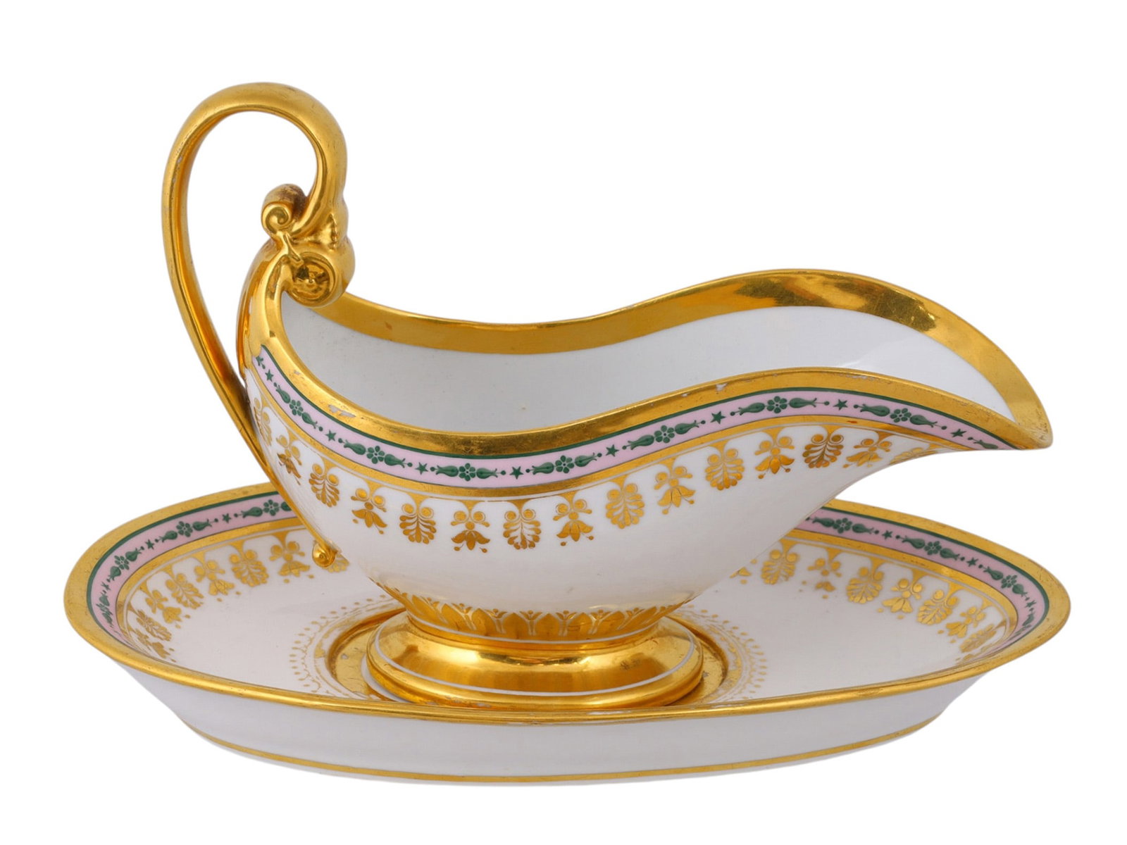 A RUSSIAN PORCELAIN SAUCEBOAT AND STAND FROM THE BABIGON SERVICE BY THE IMPERIAL PORCELAIN FACTORY,: The sauceboat of elongated oval form, with an upswept spout, gilt foot and high scrolling gilt handle terminating in moulded scrolls, the body painted with a pale pink band of green stylized flowers, 