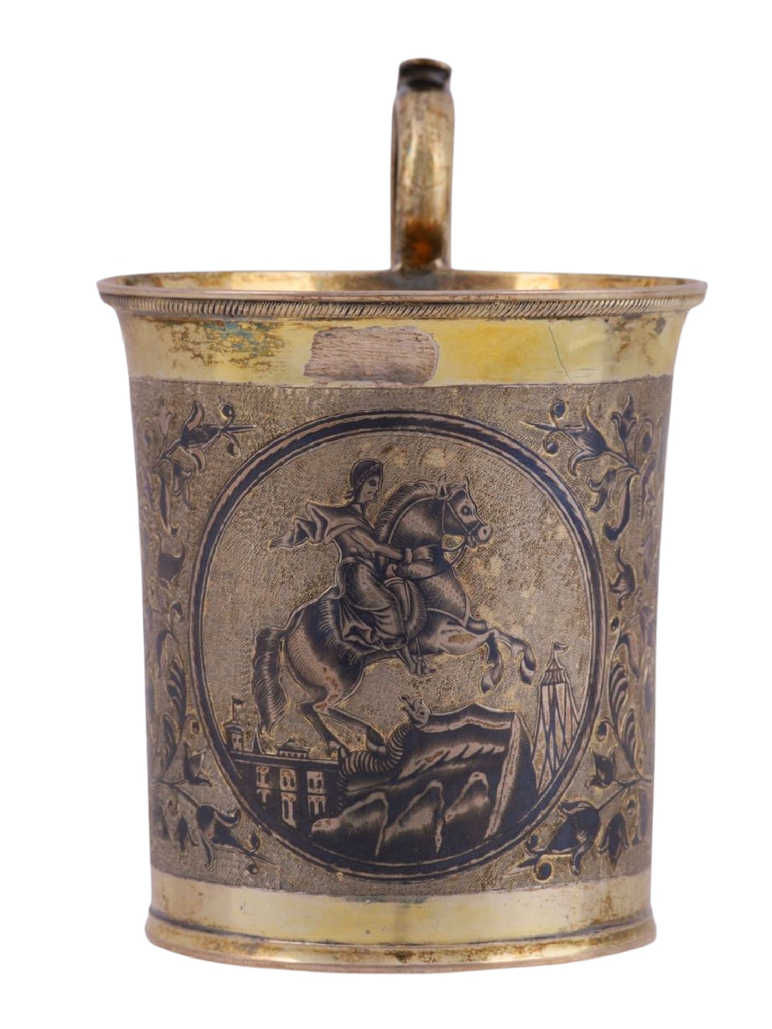 A LARGE RUSSIAN SILVER-GILT AND NIELLO CHOCOLATE CUP, 1883: Nielloed with a roundel depicting the statue of Peter the Great in St. Petersburg within foliate ornaments, raised scrolling handle decorated with acanthus leaves and flowers.Hallmarks: maker's mark "
