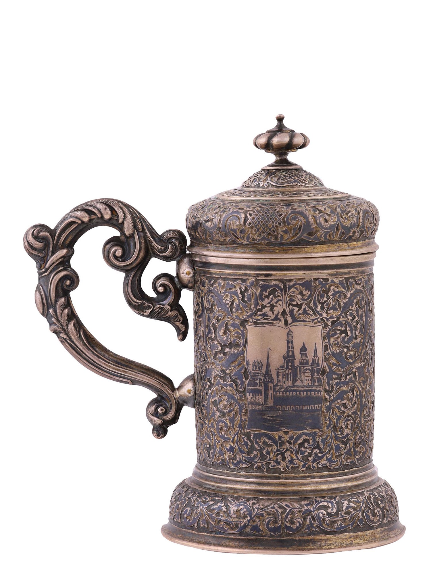 A RUSSIAN ENGRAVED GILT-SILVER AND NIELLO LIDDED TANKARD, 1850: Moscow, 1850.Elaborately decorated Russian silver niello tankard with engraved views of the Moscow Kremlin on the sides. Engraved on the front with initials "A.N" and dated 1850.Hallmarks: "AK" maker'